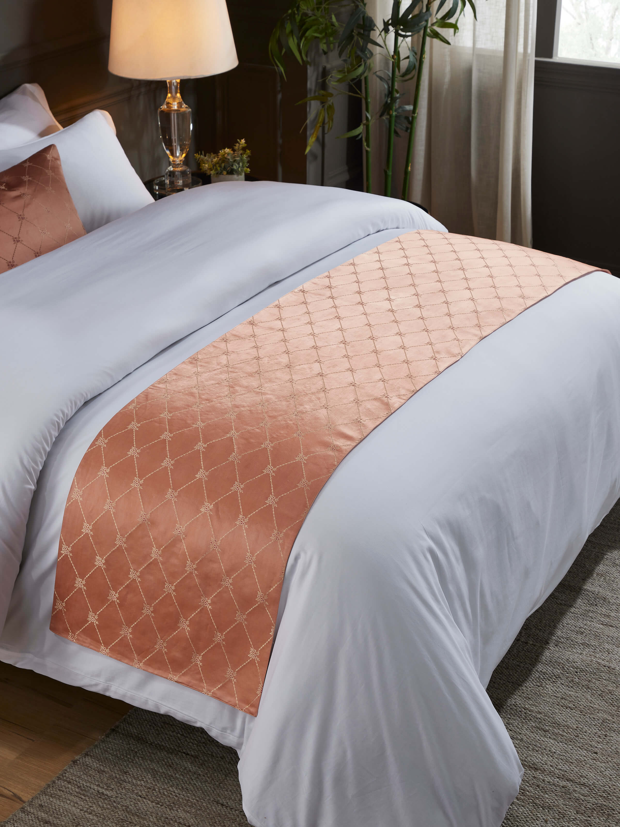 Lifestyle shot of Banarasi bed runner styled on a neutral bed for an elegant ethnic touch.