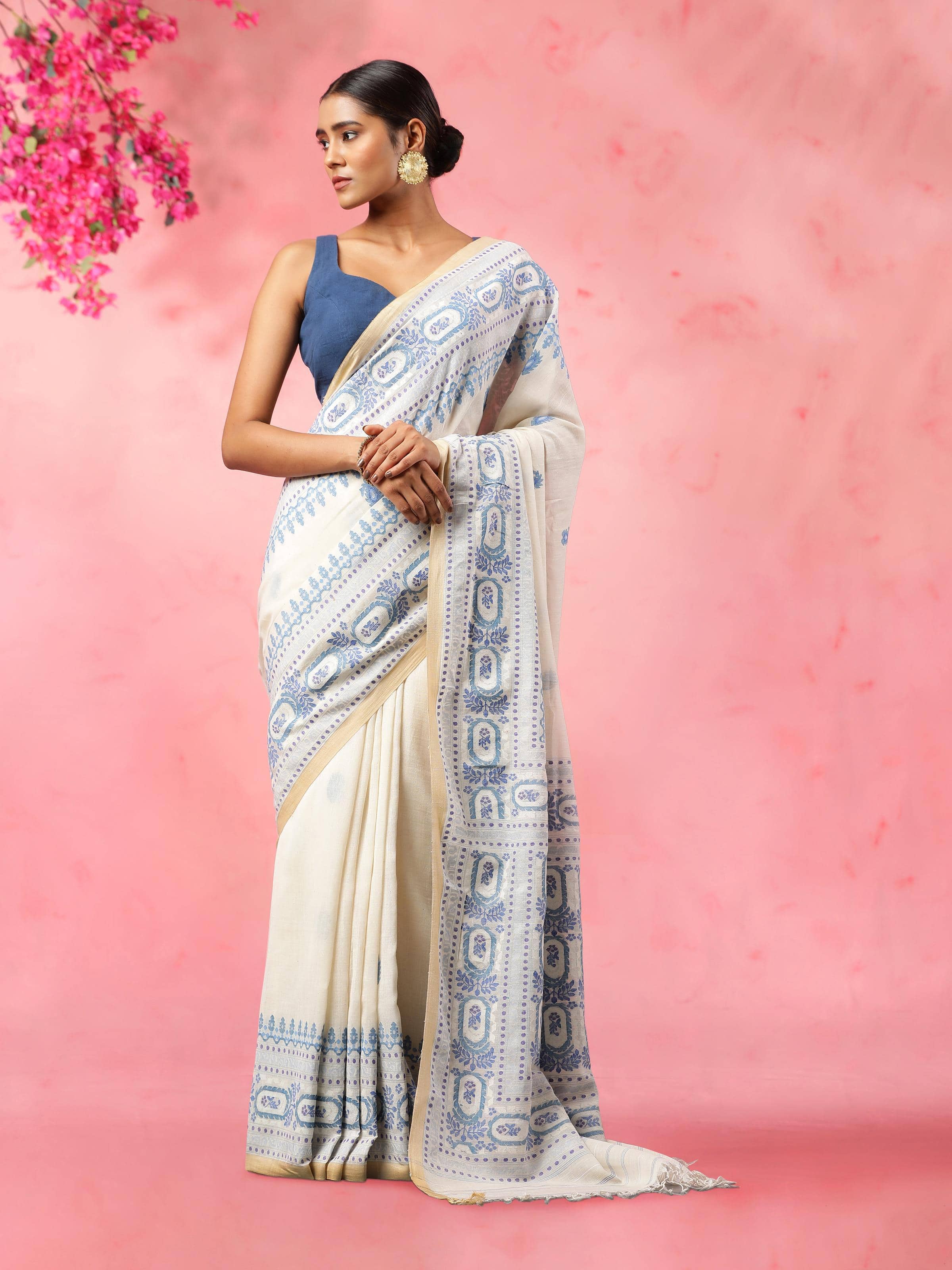 Lifestyle view of off-white cotton Jamdani saree draped elegantly with traditional motifs