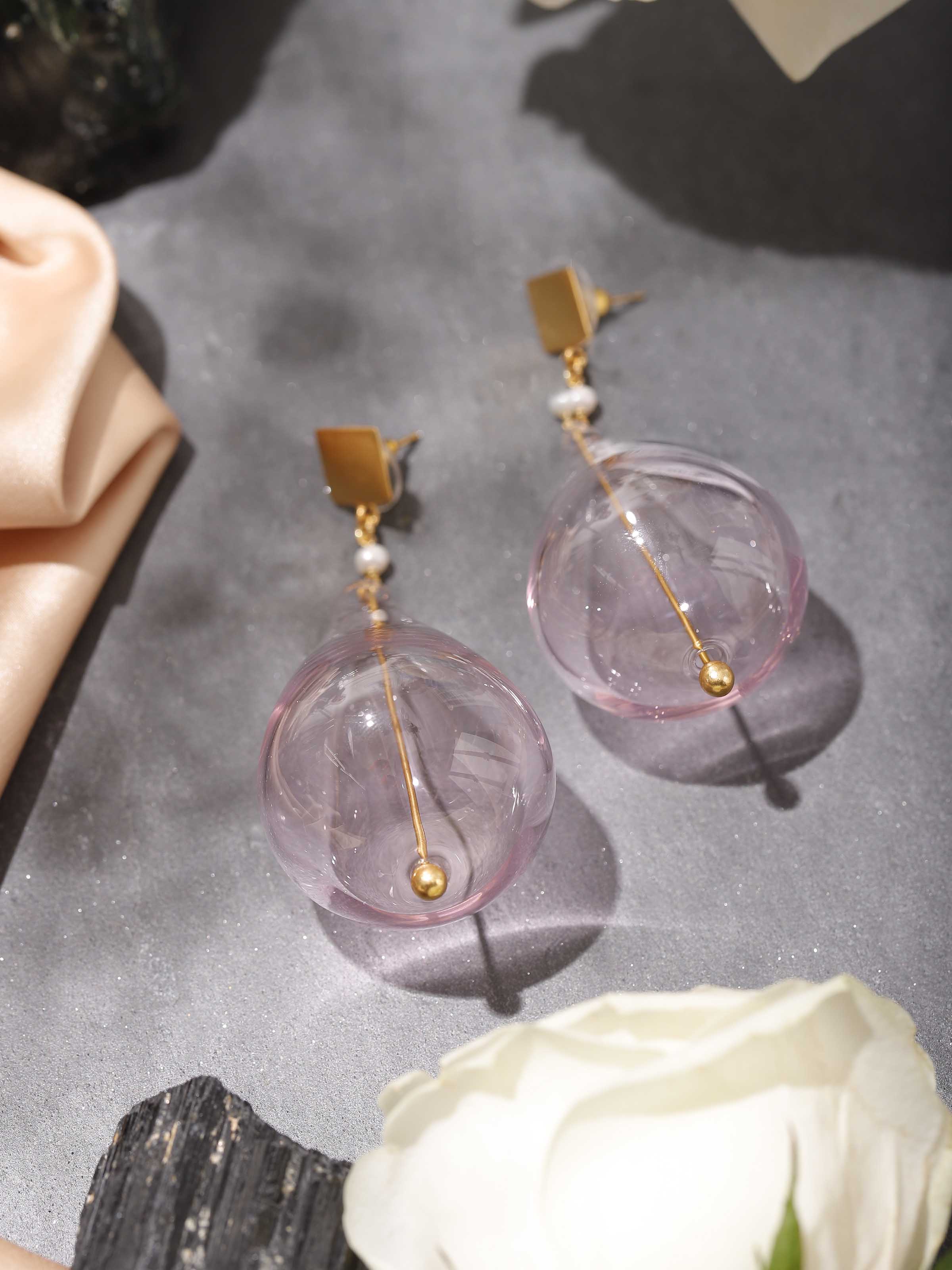 Lifestyle view of silver flame glass drop earrings