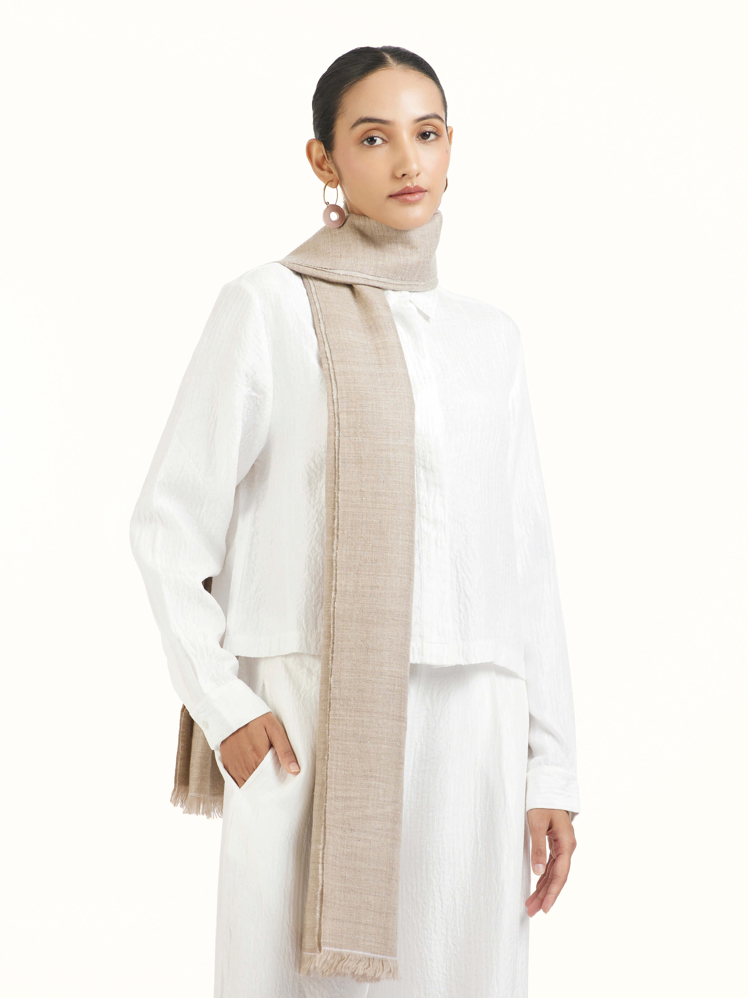 Angled view of beige cashmere stole emphasizing delicate weave