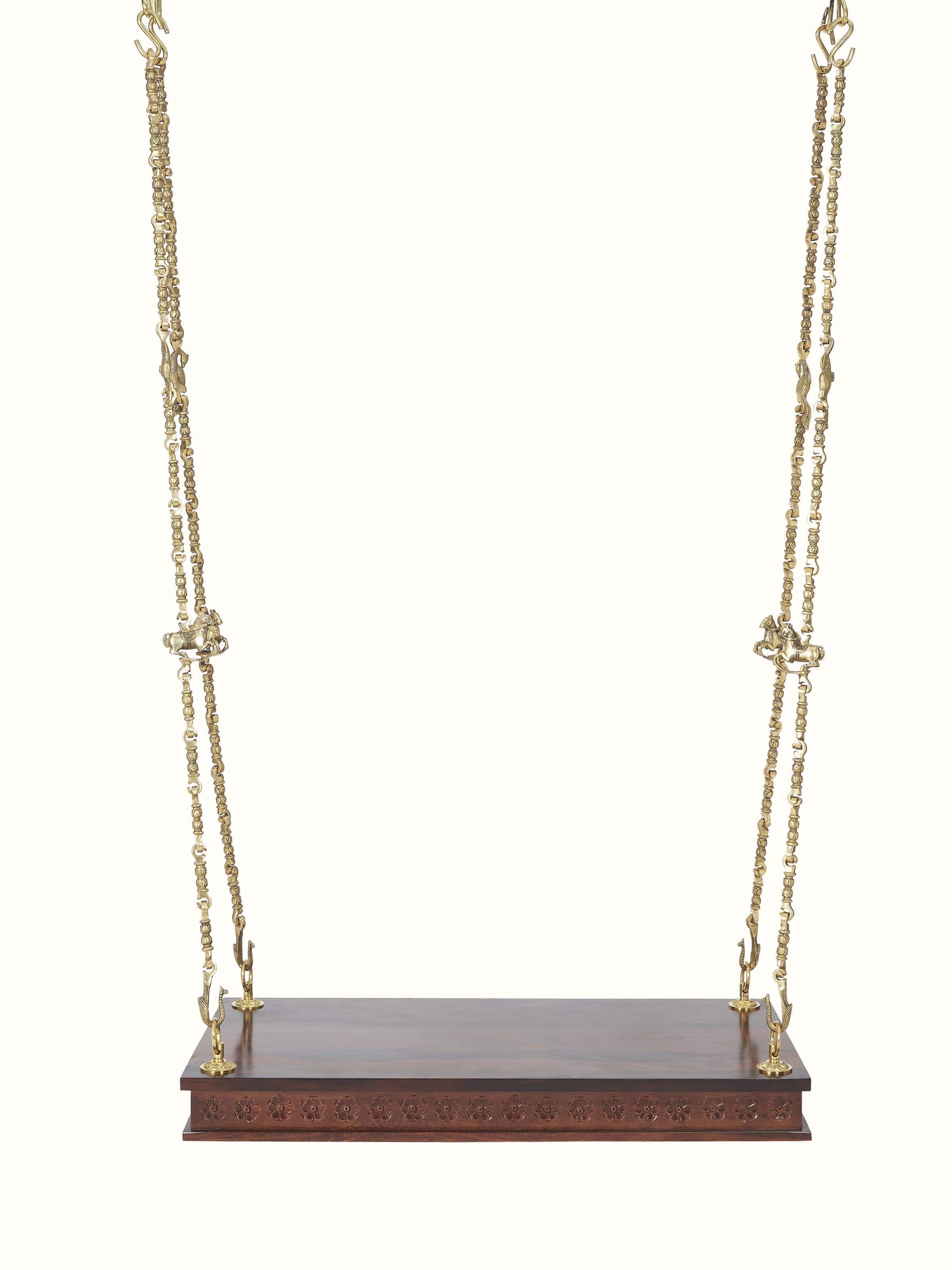 Front view of carved Sheesham wood and brass swing, highlighting its intricate design and elegant craftsmanship.