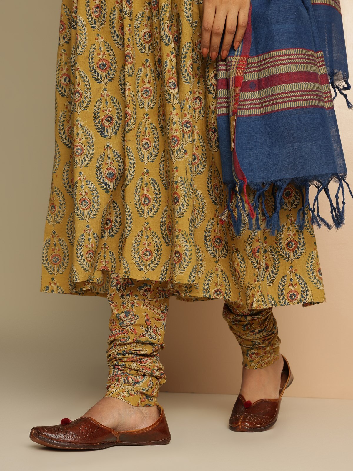 Angled view of Yellow Cotton Kalamkari Block Printed Churidaar showcasing vivid yellow color and print texture.