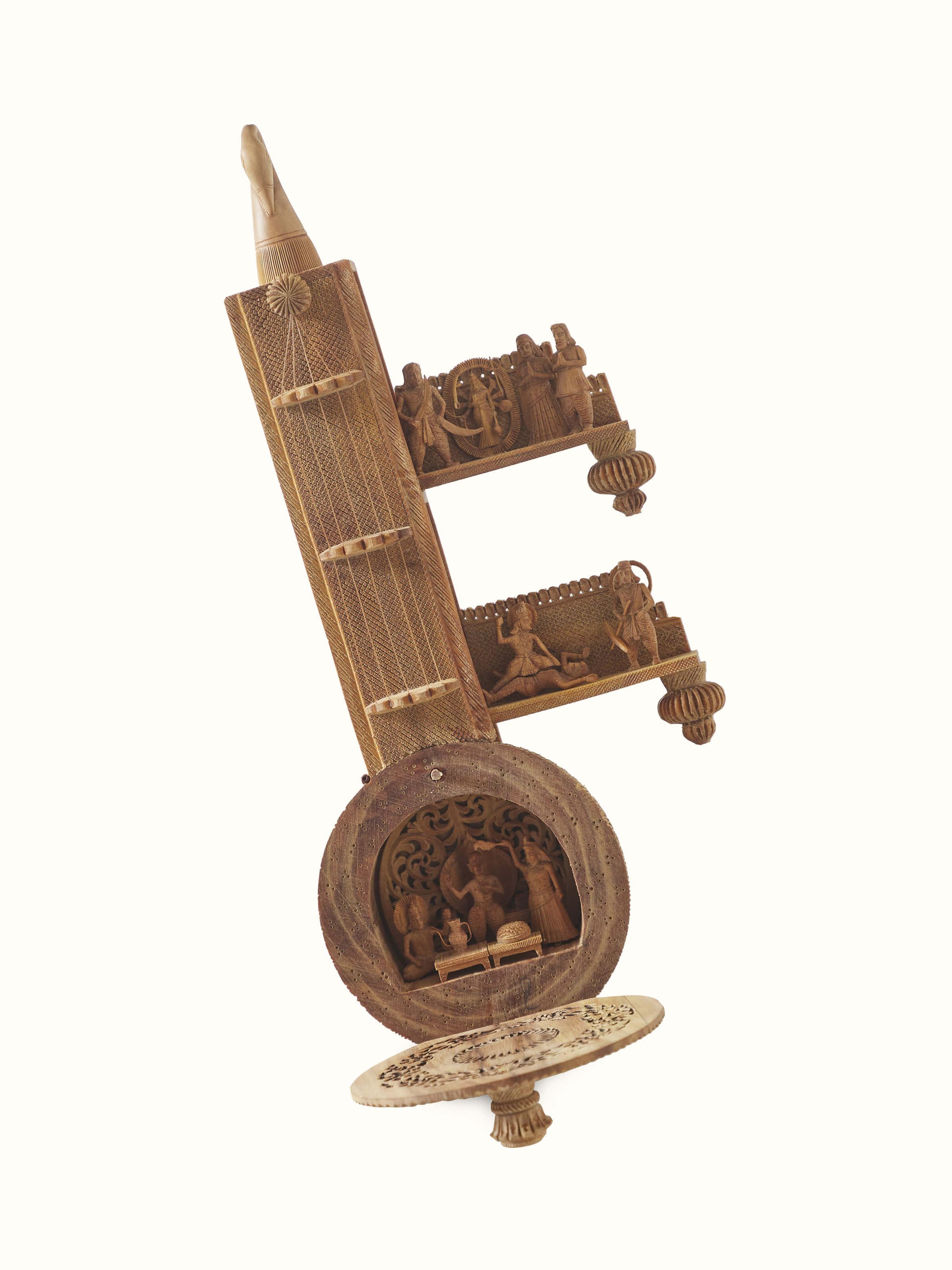 Detailed view of carved sandalwood devotion veena sculpture, showcasing the fine detailing and artistic carvings.