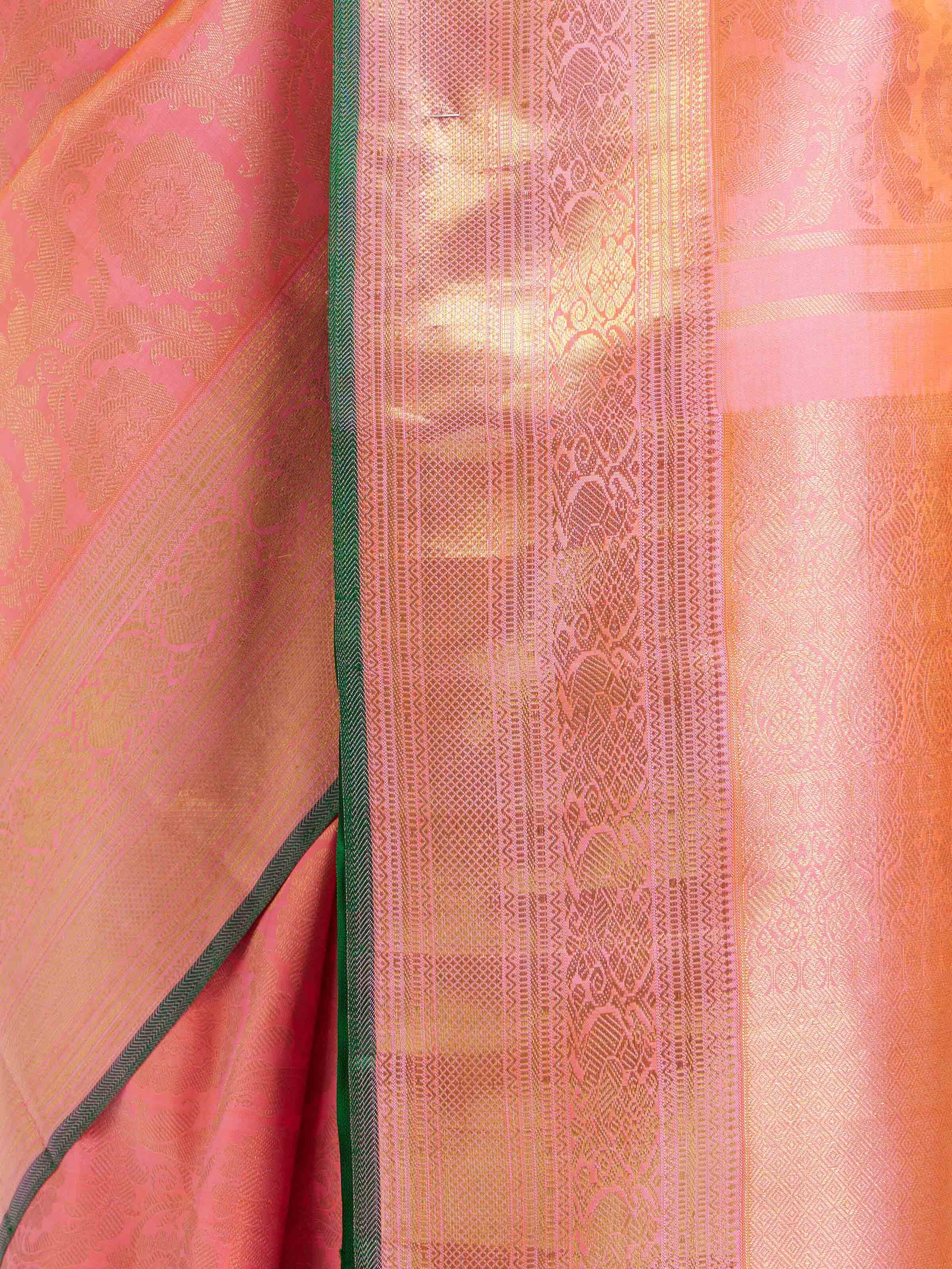 Detail view of pink silk Kancheepuram saree showing silk texture and zari craftsmanship