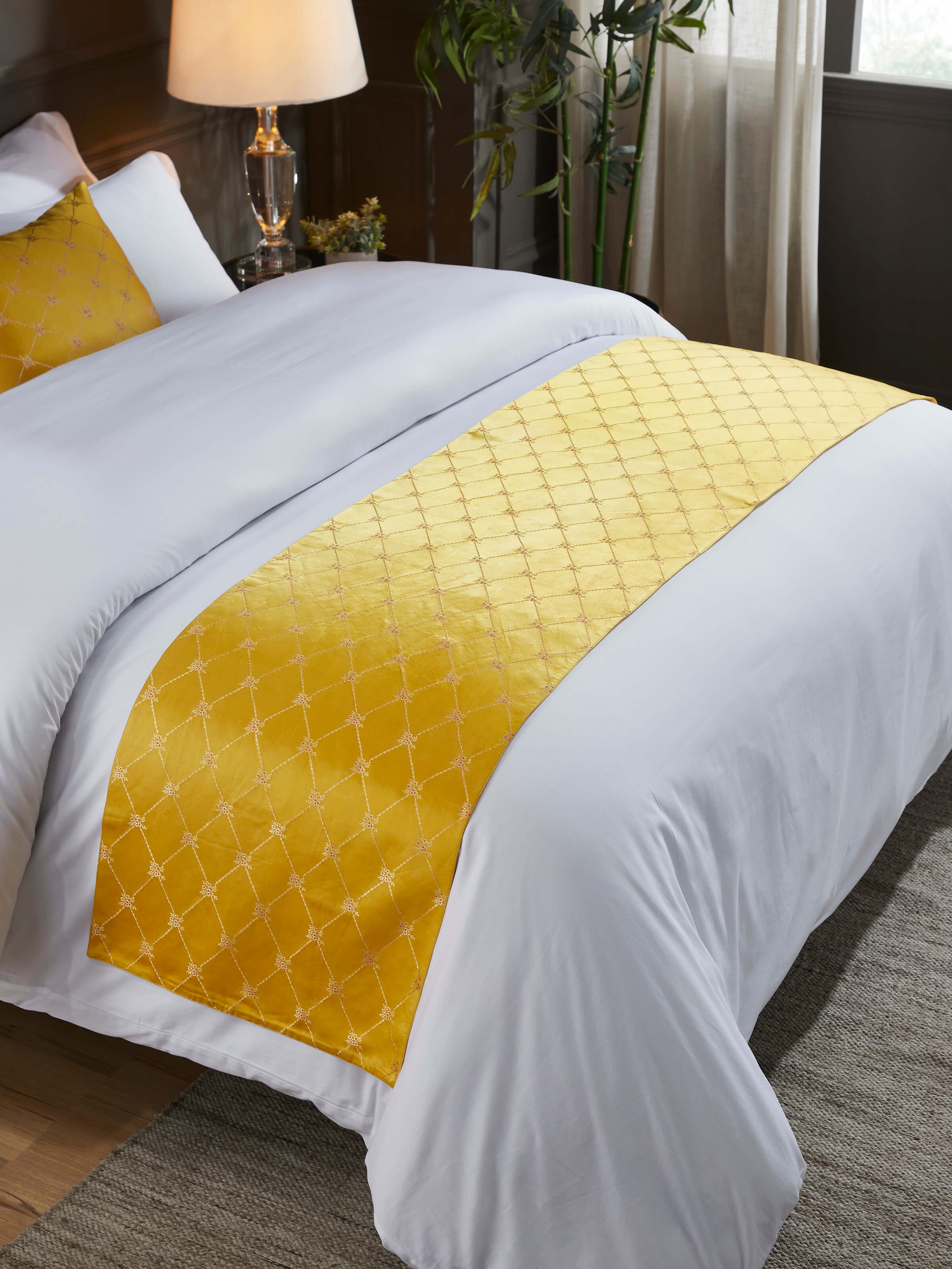 Lifestyle view of Awadh Yellow Banarasi Handloom Silk Bed Runner on a bed, emphasizing its royal look and fine detailing.