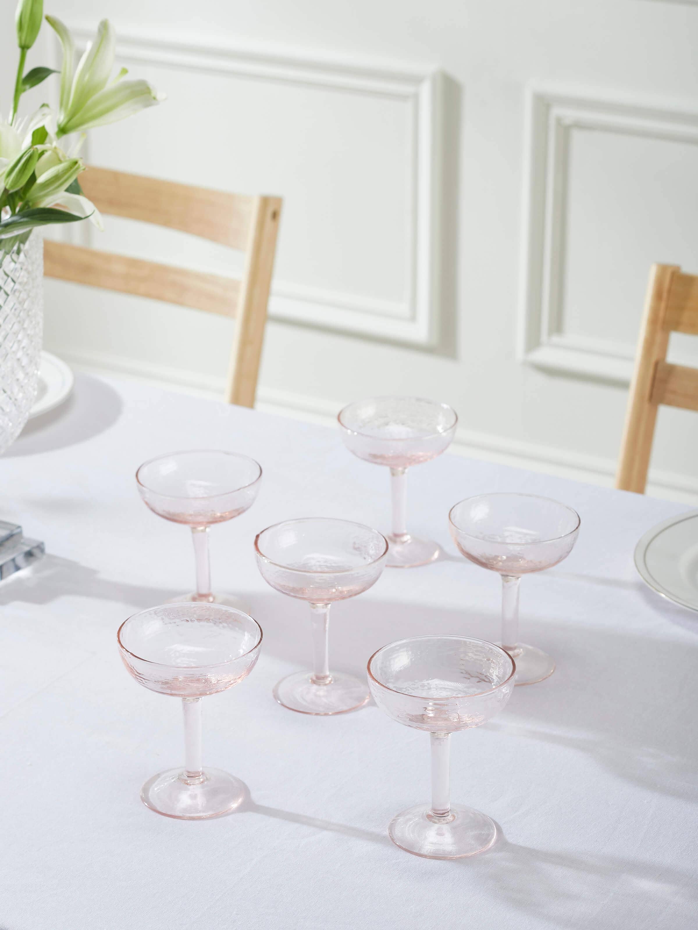 Side view of Glass-worked Wine Glasses in pink focusing on the shape and design of the glasses.