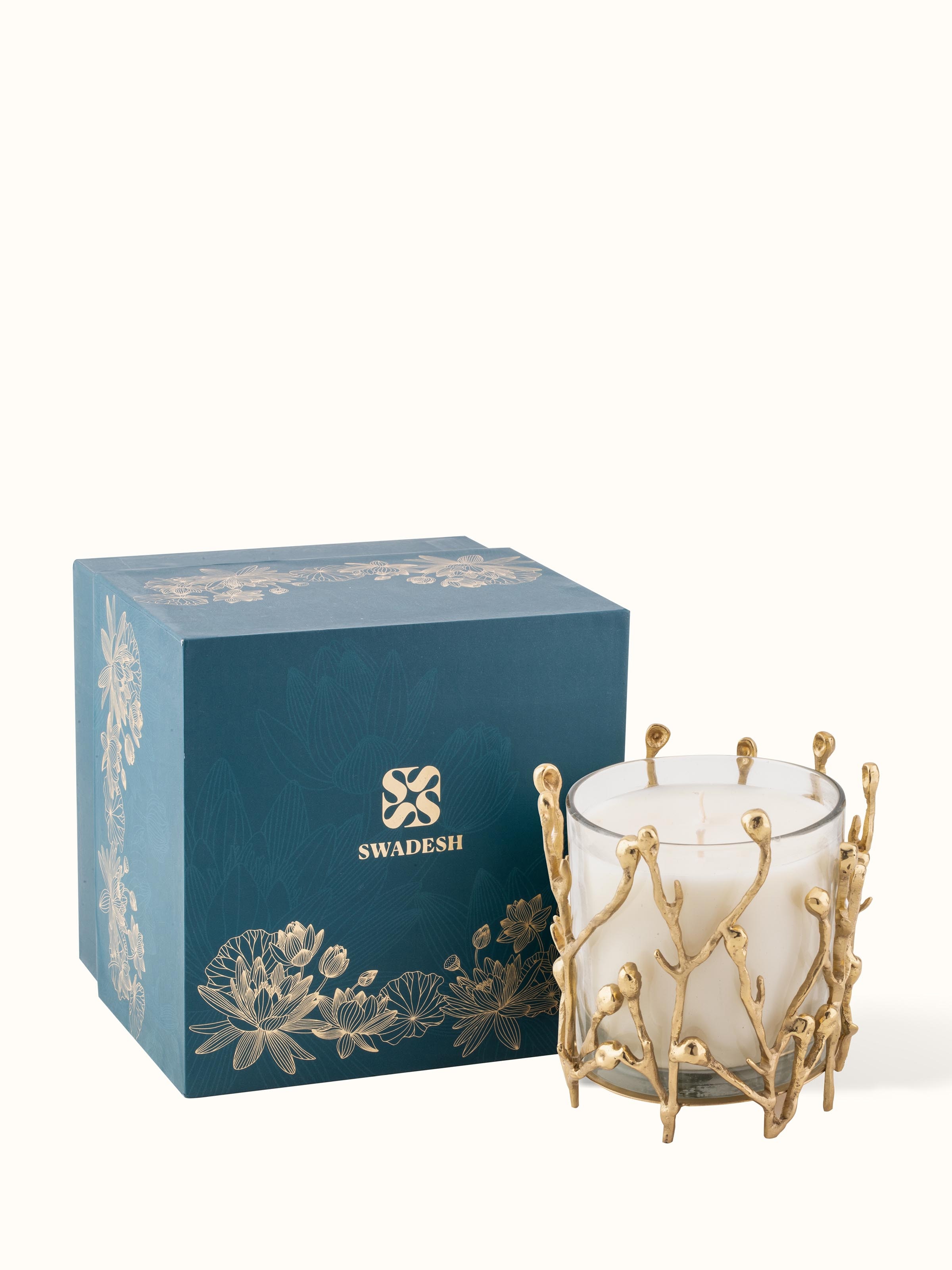 Medium brass candle displayed on a decorative table setting, emphasizing its use in home decor