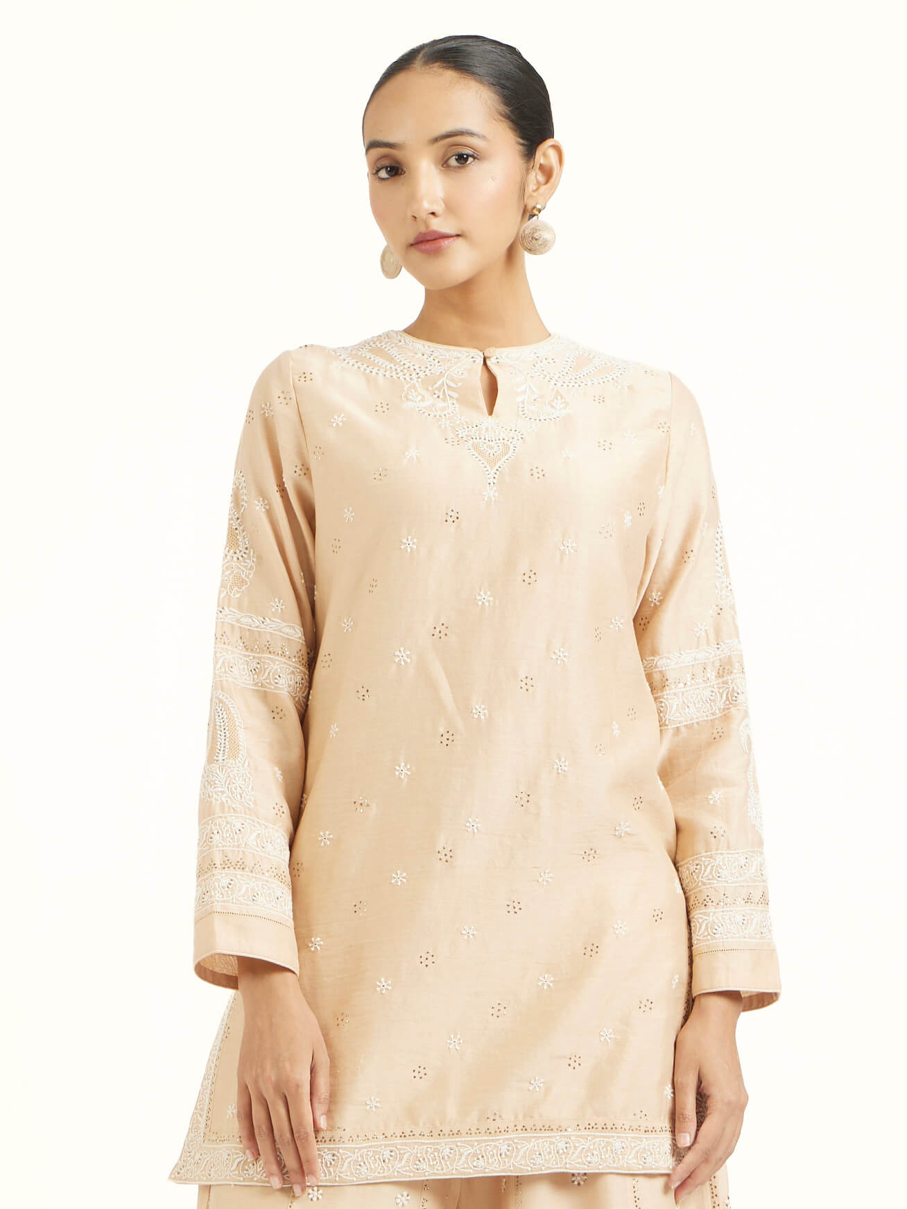 Angled view of beige silk Chanderi kalidar sharara highlighting flow and design