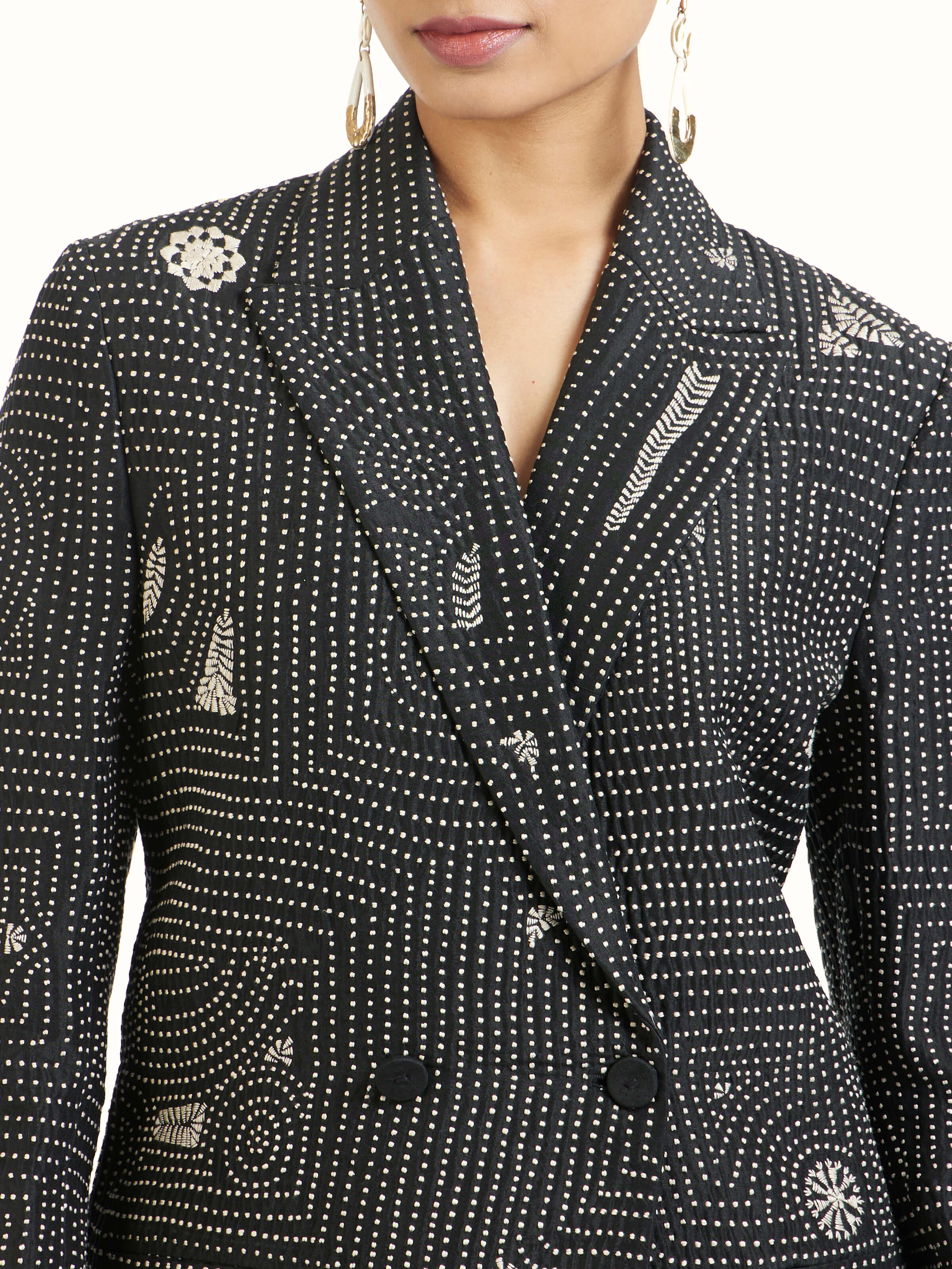 Detail view of black silk kantha jacket showing embroidery texture