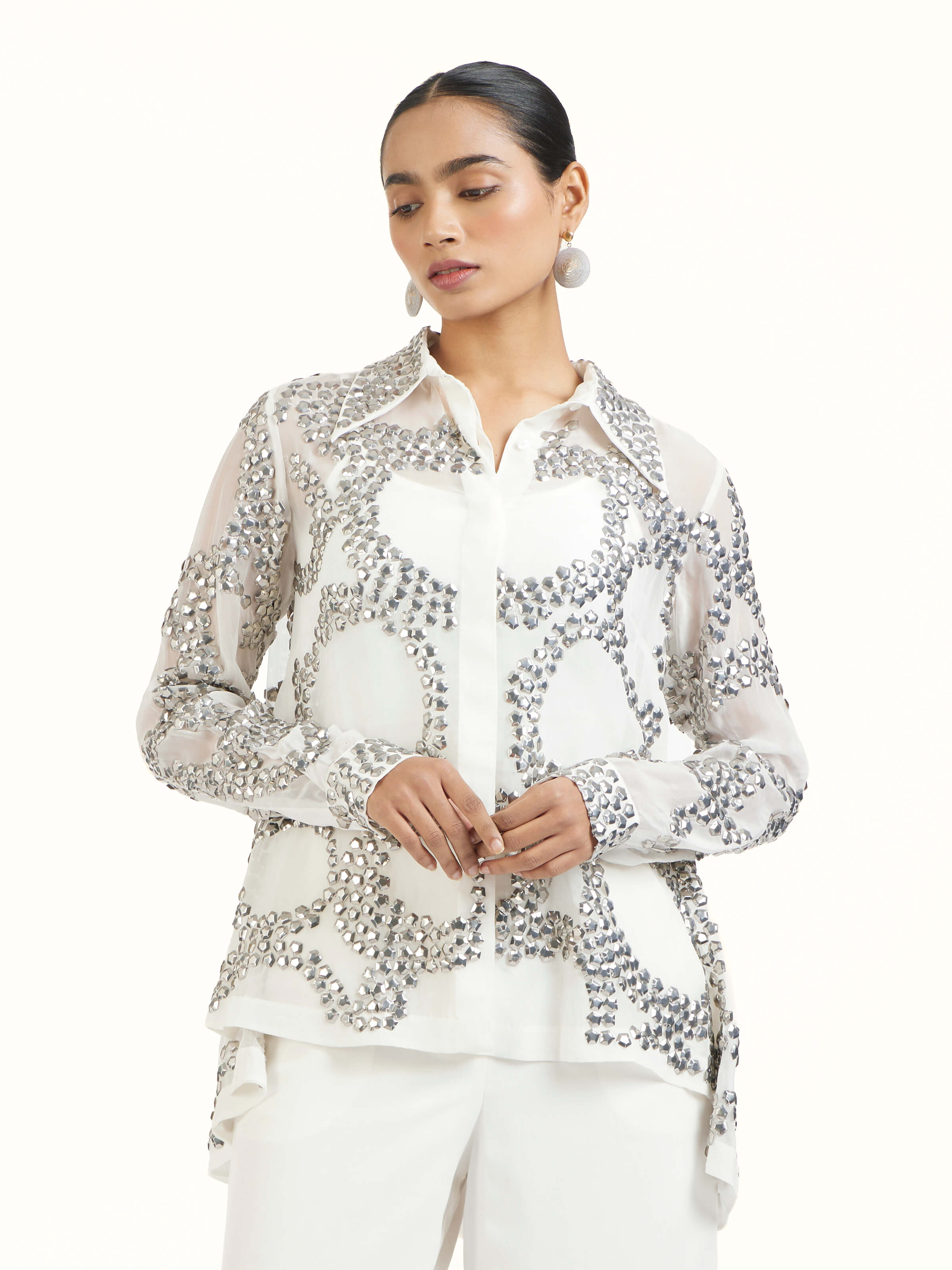 Angled view of ivory hand embroidered organza silver shirt highlighting handcrafted detailing