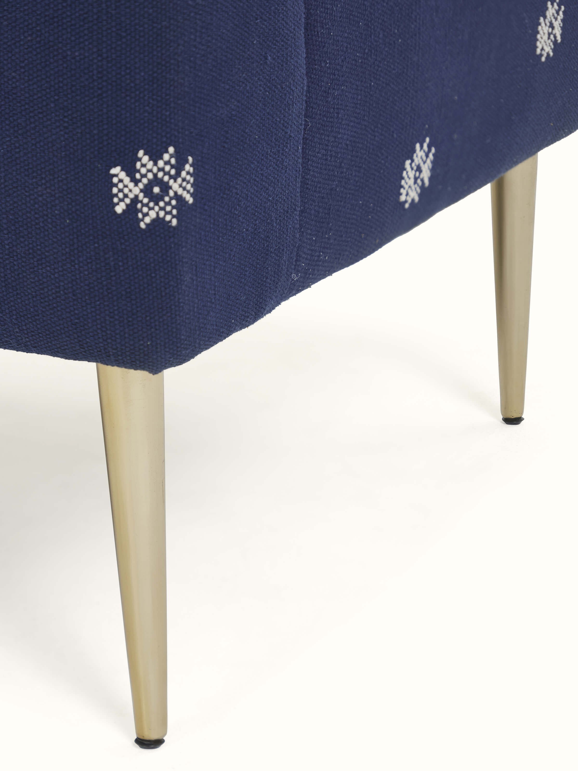Close-up view of Upholstered Metal Wing Chair, showcasing the rich fabric texture and intricate metalwork