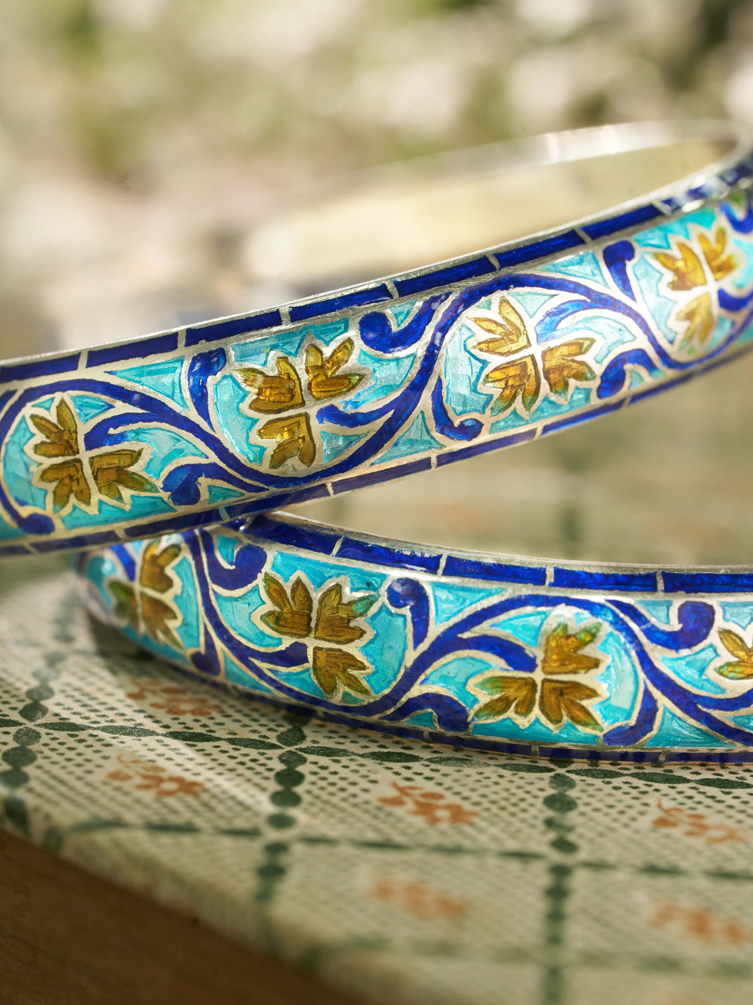 Detailed view of blue meenakari silver bangles' enamel detailing and finish.