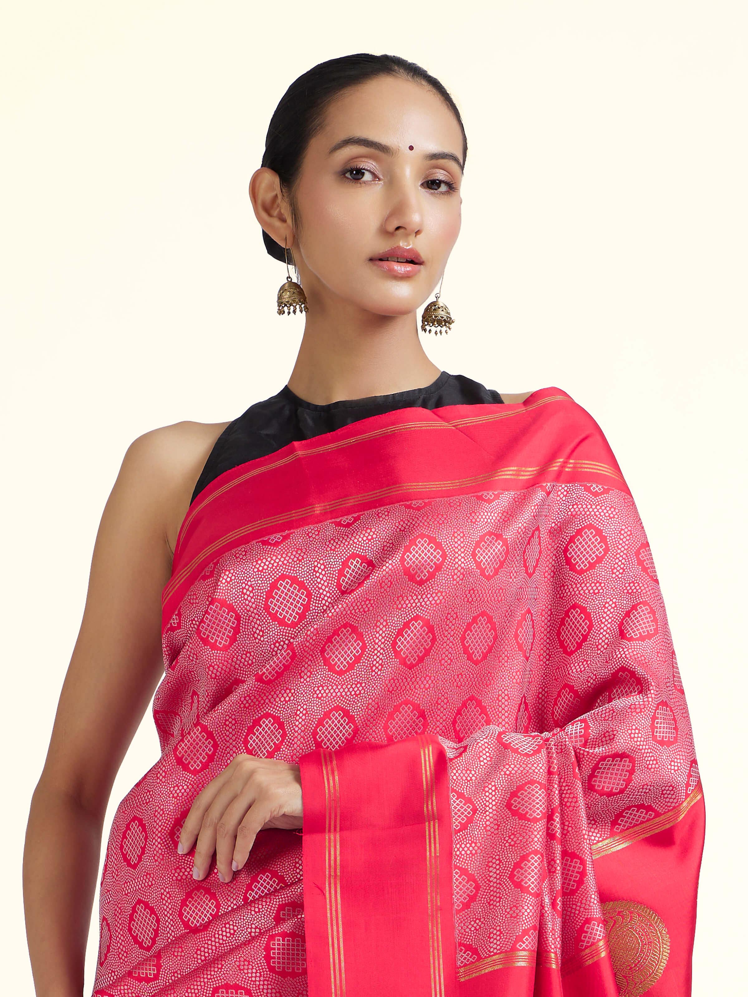 Angled view of red silk Kancheepuram saree highlighting traditional weave and sheen
