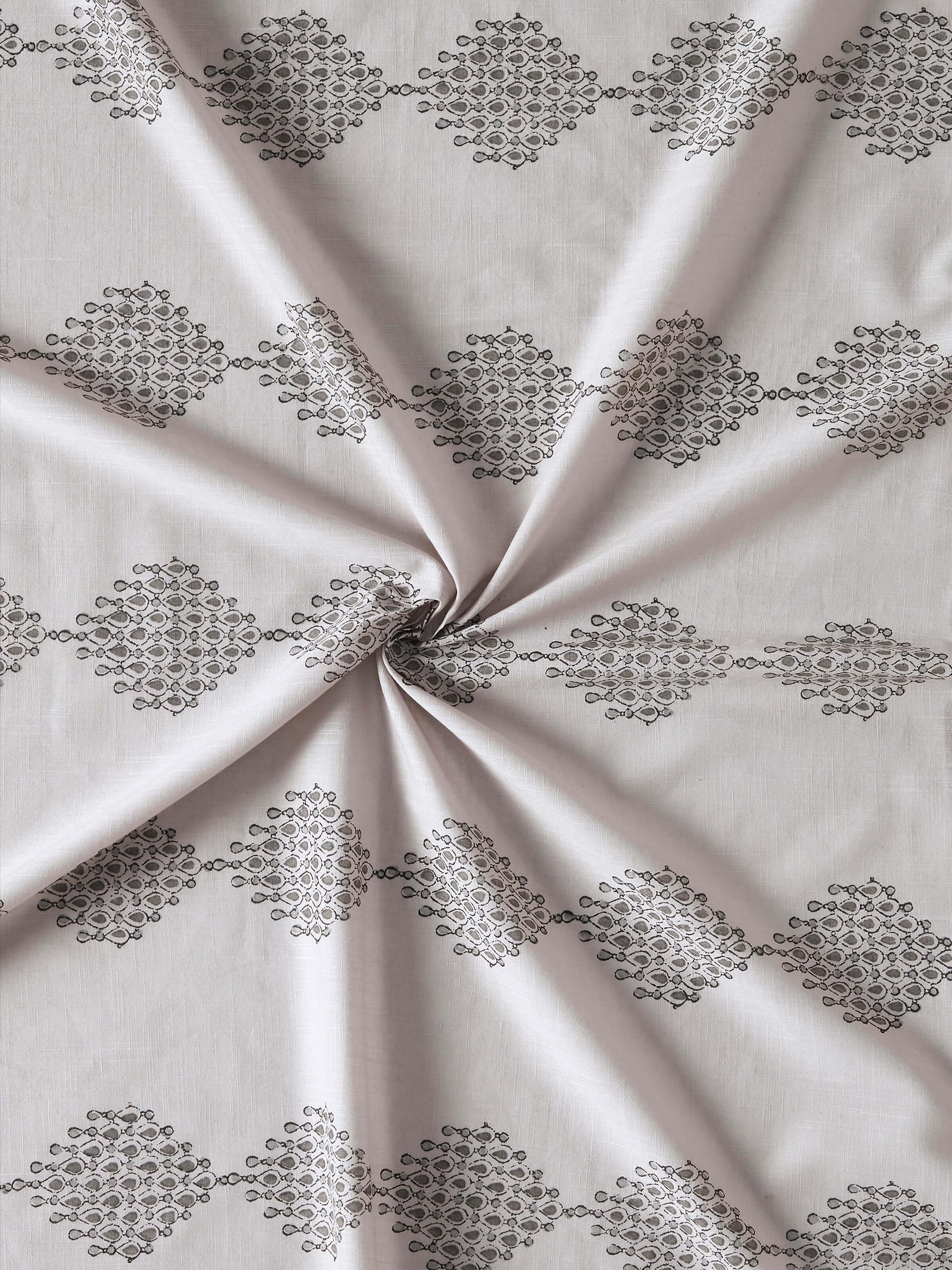 Detailed shot showcasing Sanganeri block printed geo pattern on Rambagh light grey curtain
