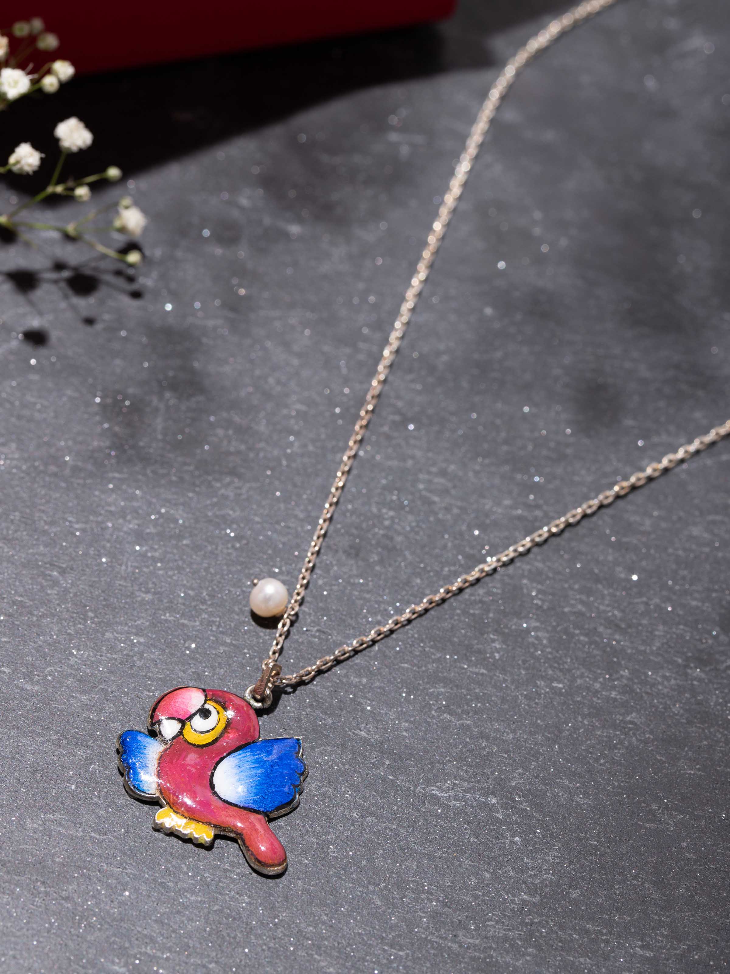 Close-up of Gulabi Meenakari pendant worn with ethnic outfit, emphasizing its vivid pink enamel design.