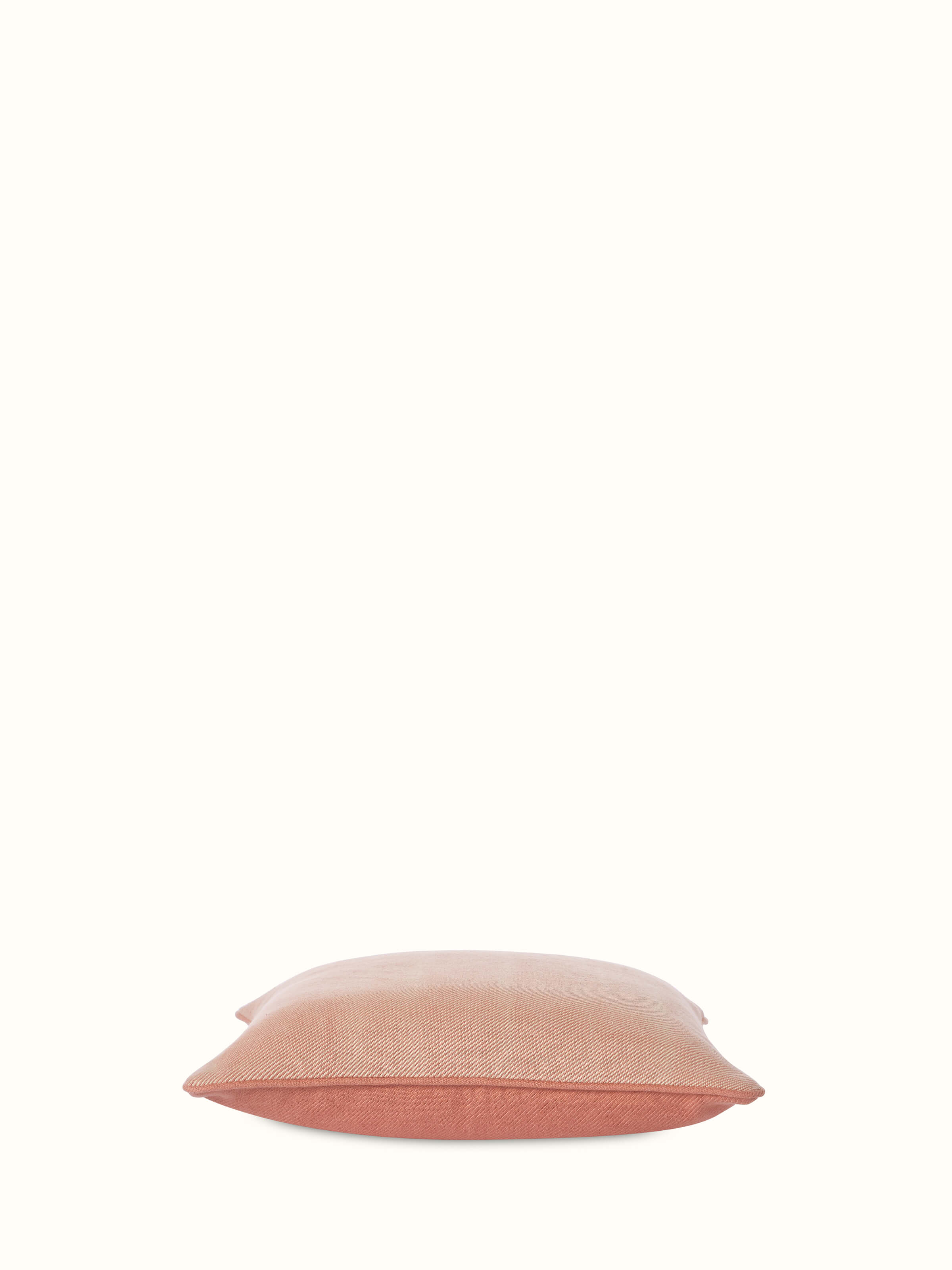 Angled view of Godna Peach Diamond Cotton Handwoven Pattu Cushion Cover showing the dimensional texture and diamond design