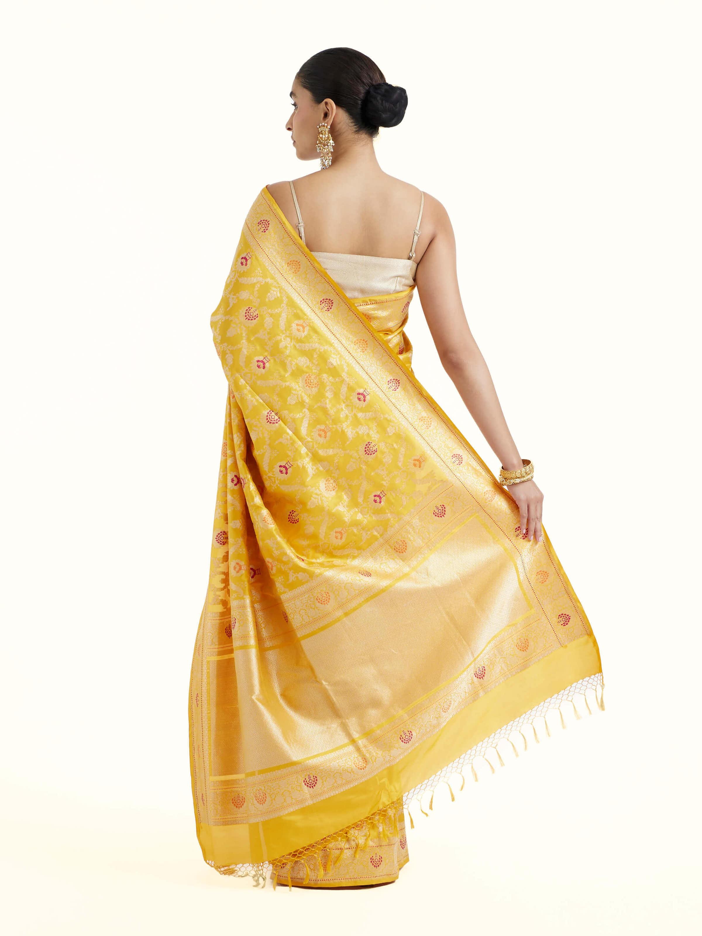 Back view of yellow Banarasi silk kadwa jaal saree displaying elaborate pallu design