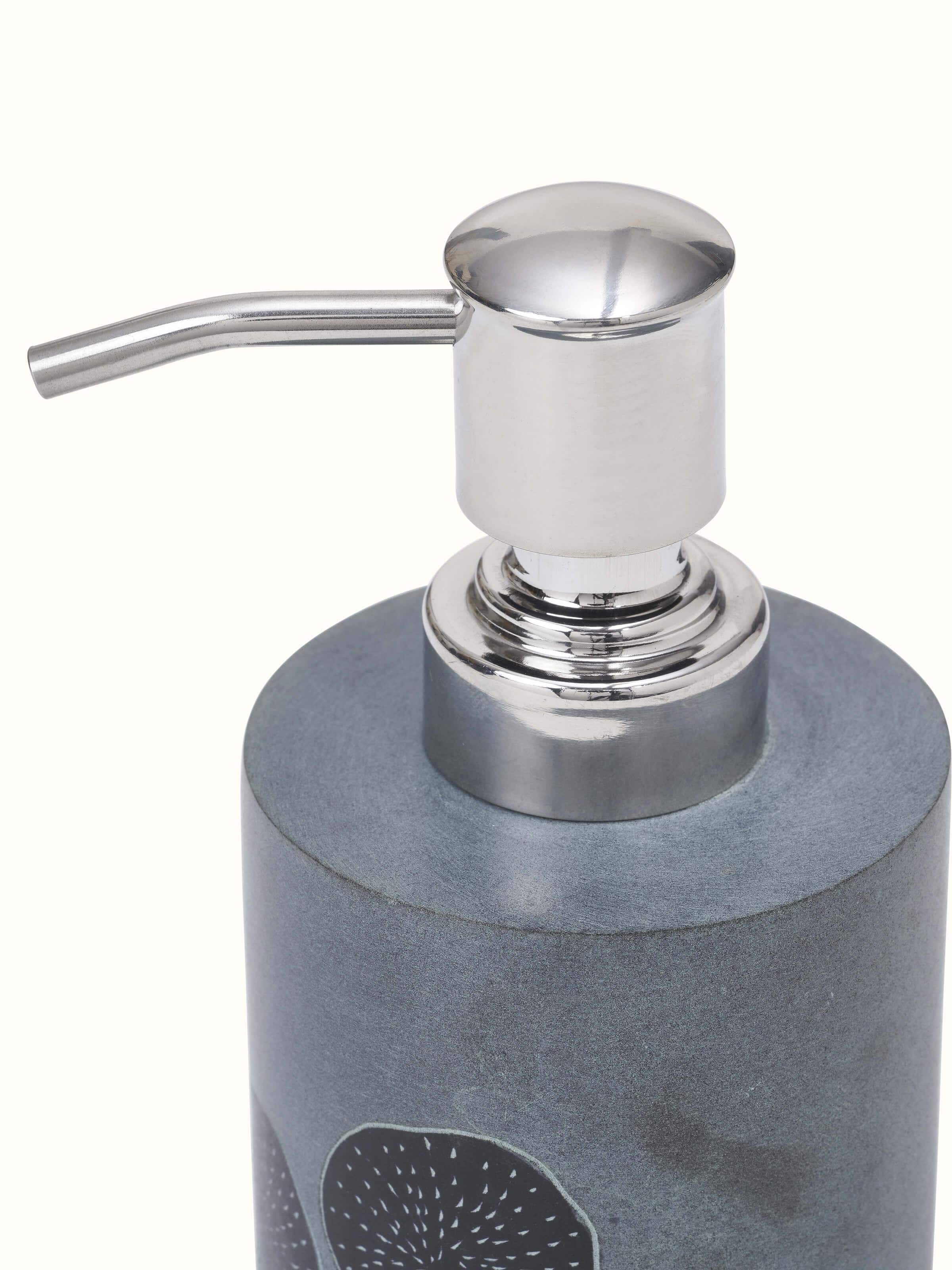 Detailed view of carved stone soap dispenser displaying the fine craftsmanship and refined texture.