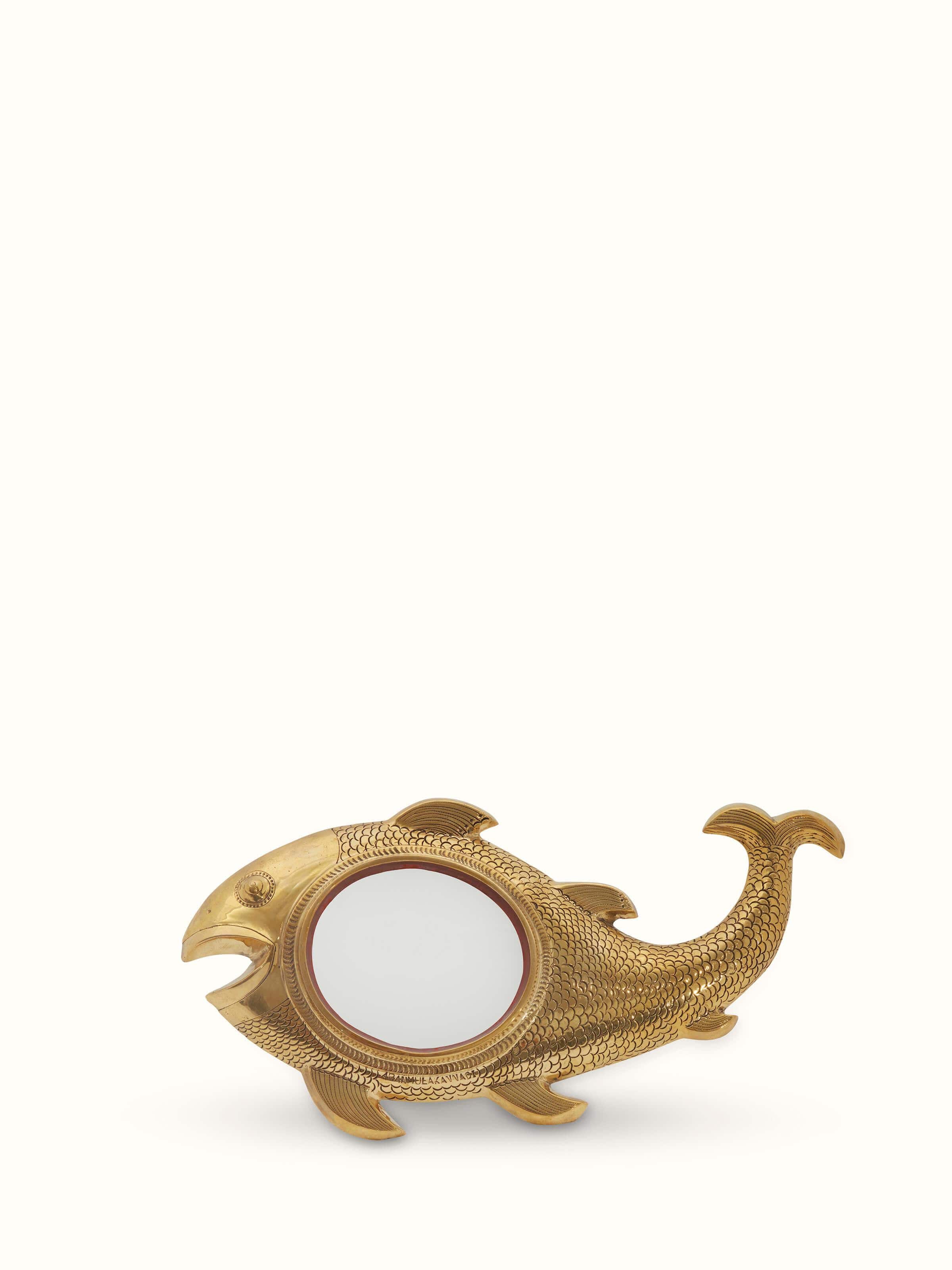 Front view of Aranmula kannadi brass mirror with ornate design.