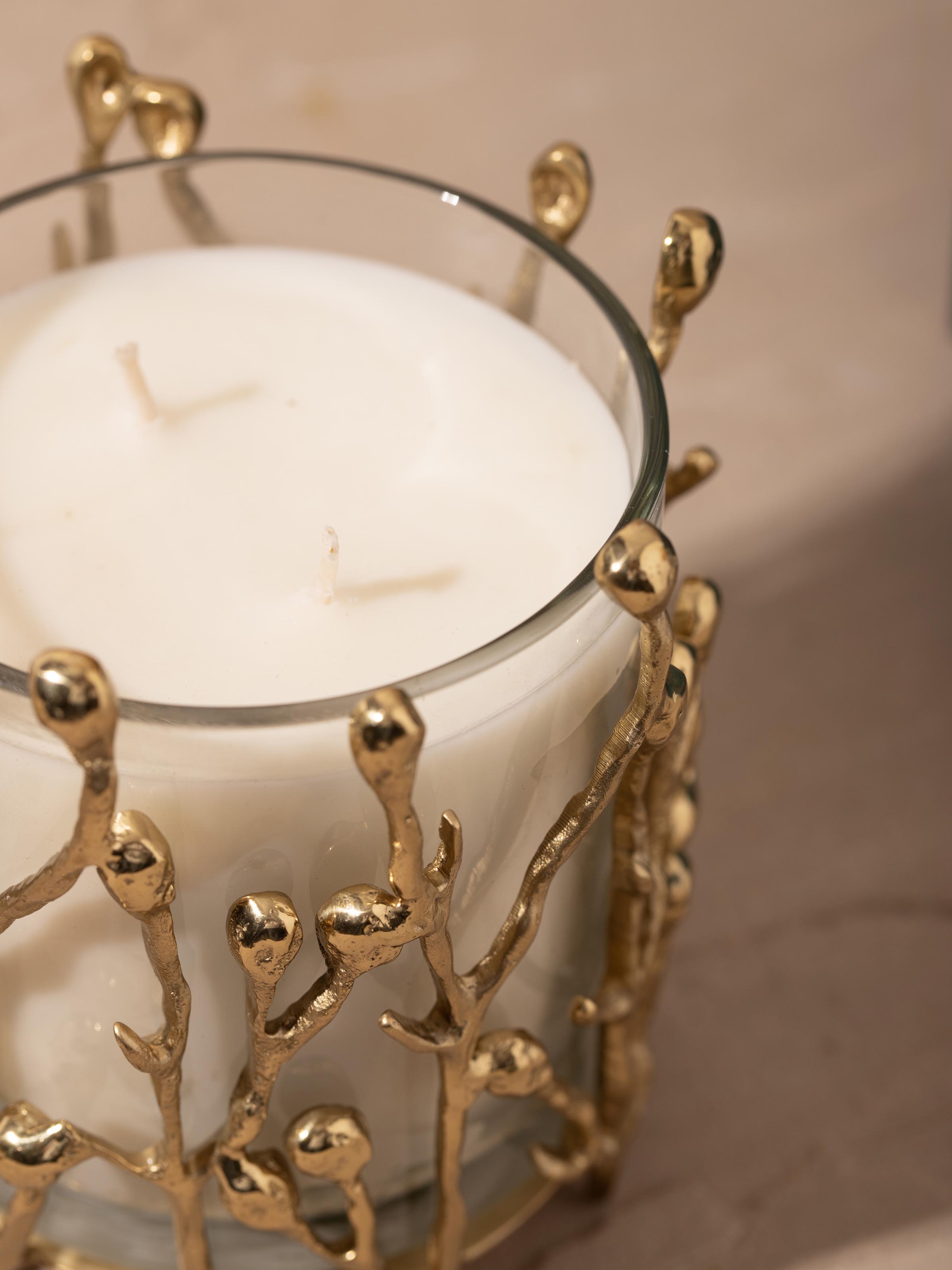 Close-up view of medium brass candle revealing the wick and candle holder design
