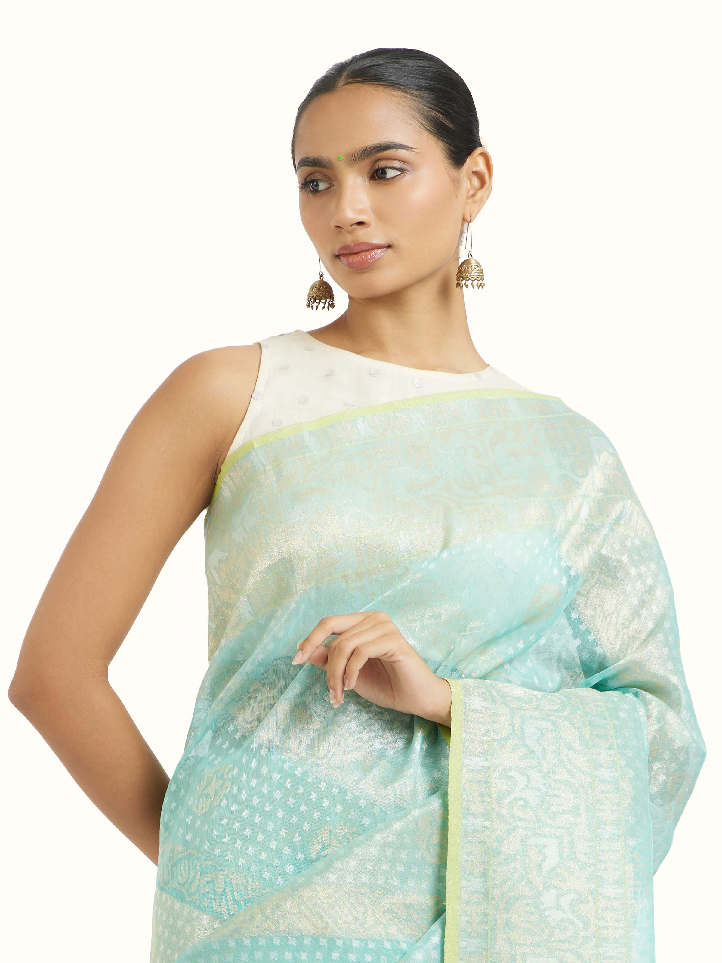 Angled view of turquoise cotton Awadh Jamdani Banarasi saree highlighting jamdani patterns