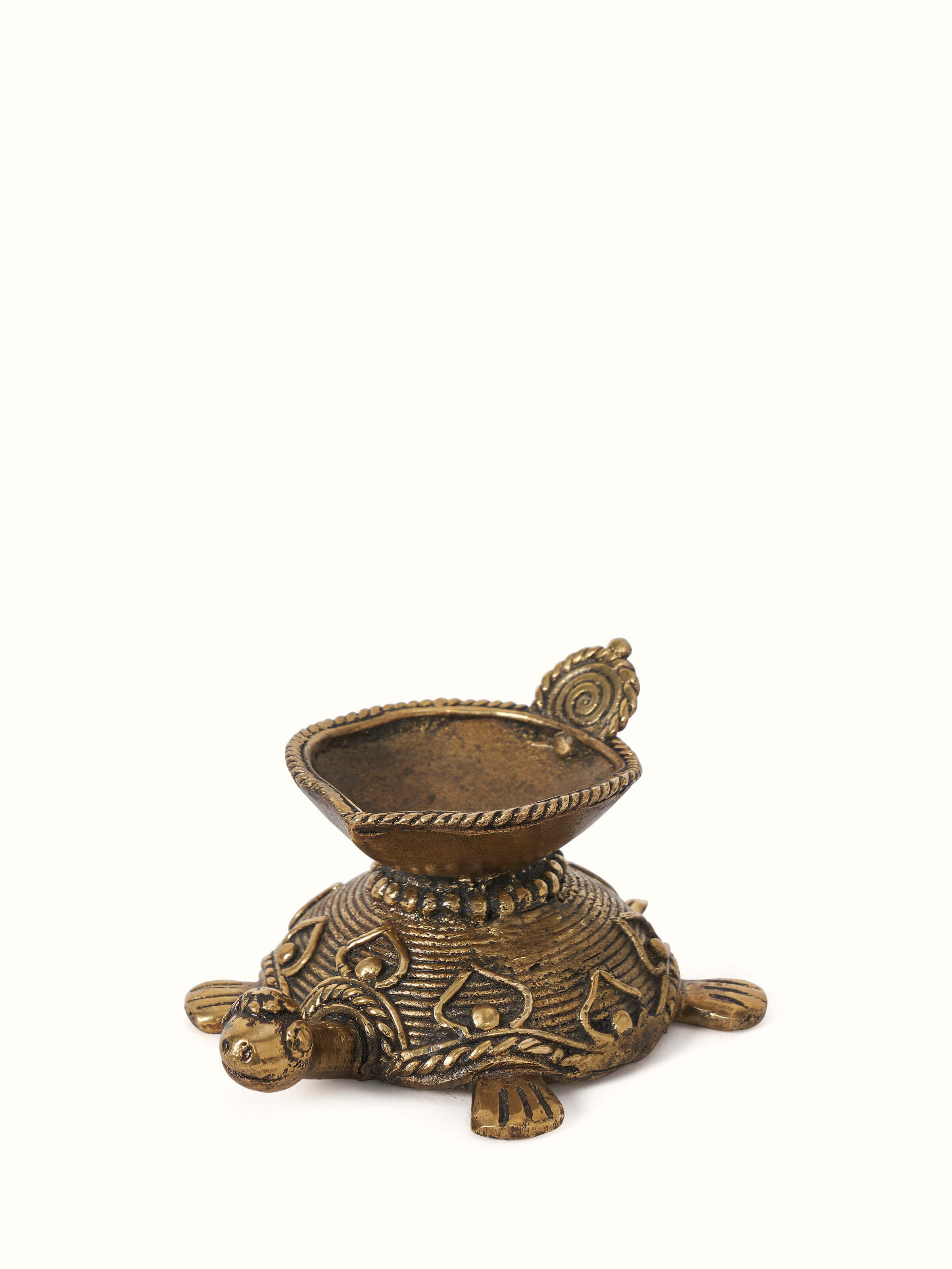 Side view of Dhokra Brass Diya highlighting the detailed metalwork and design.