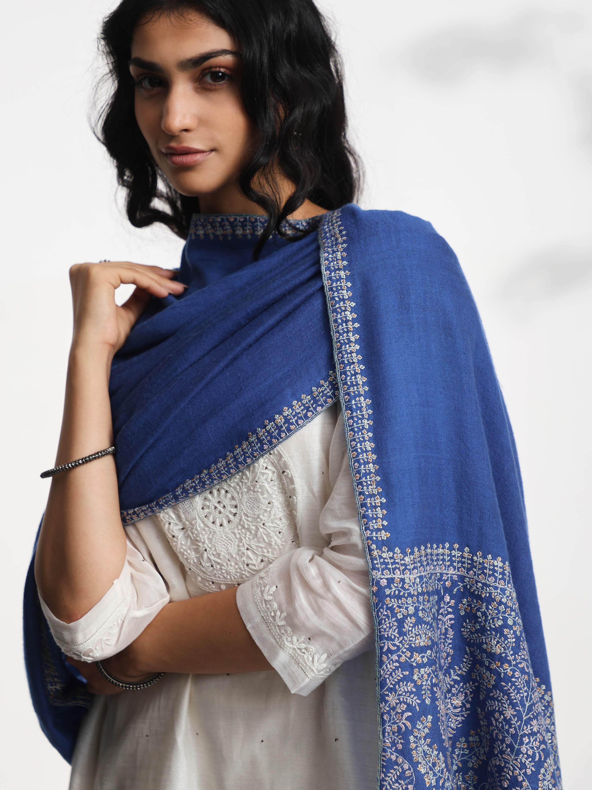 Detail view of blue Palledar Sozni embroidered shawl showing fine threadwork