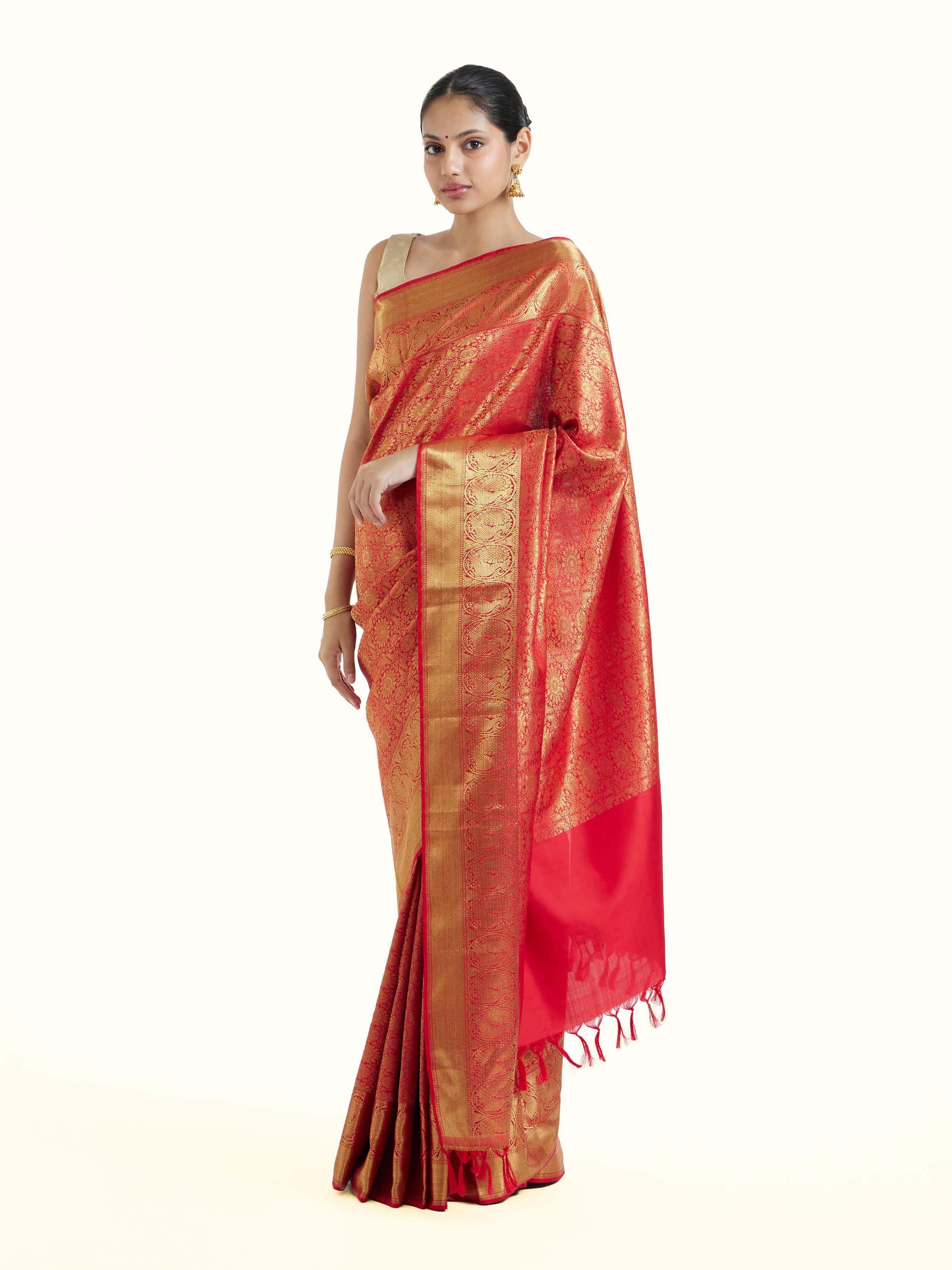 Side view of pink silk Kancheepuram saree highlighting graceful drape and contrast border