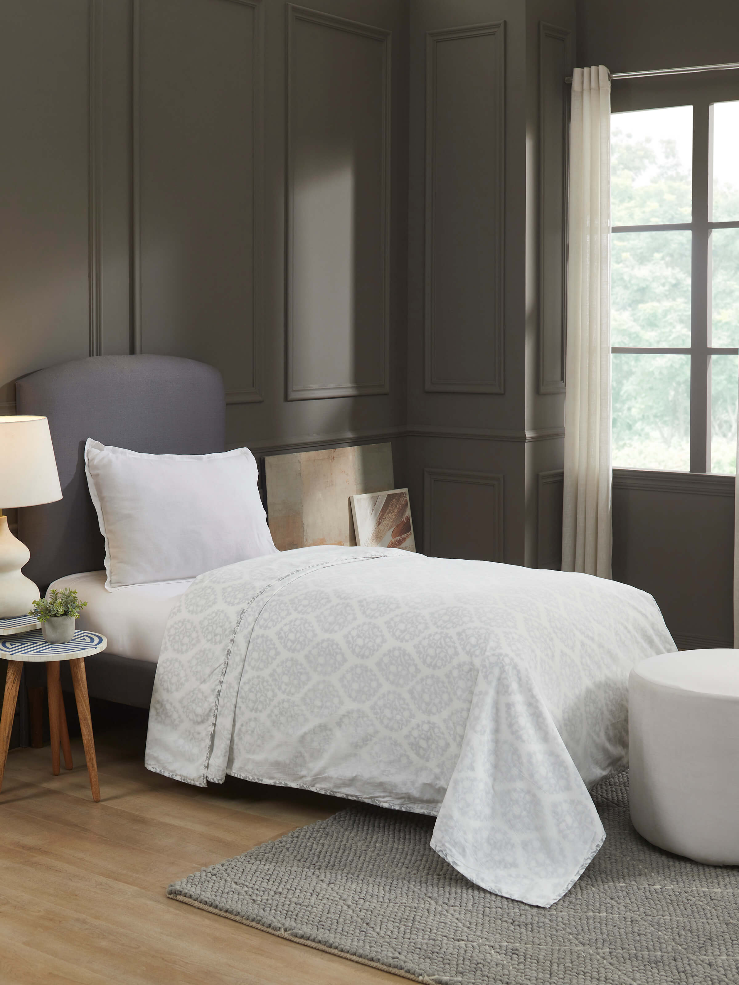 Lifestyle image of Mihrab hand block printed dohar on a bed, displaying soft cotton texture.