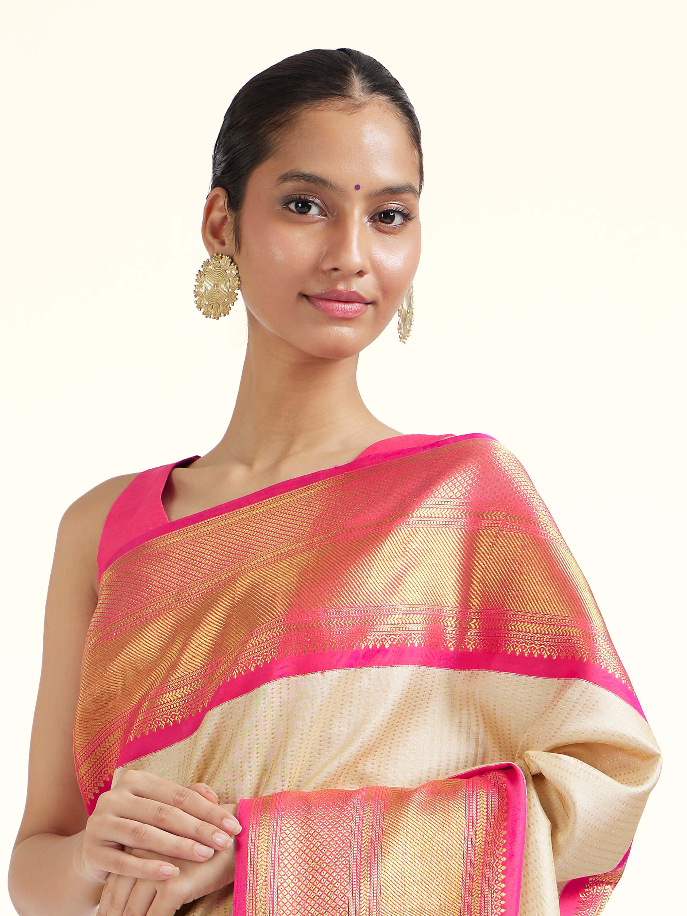 Angled view of cream silk Kancheepuram saree highlighting traditional weave and soft sheen