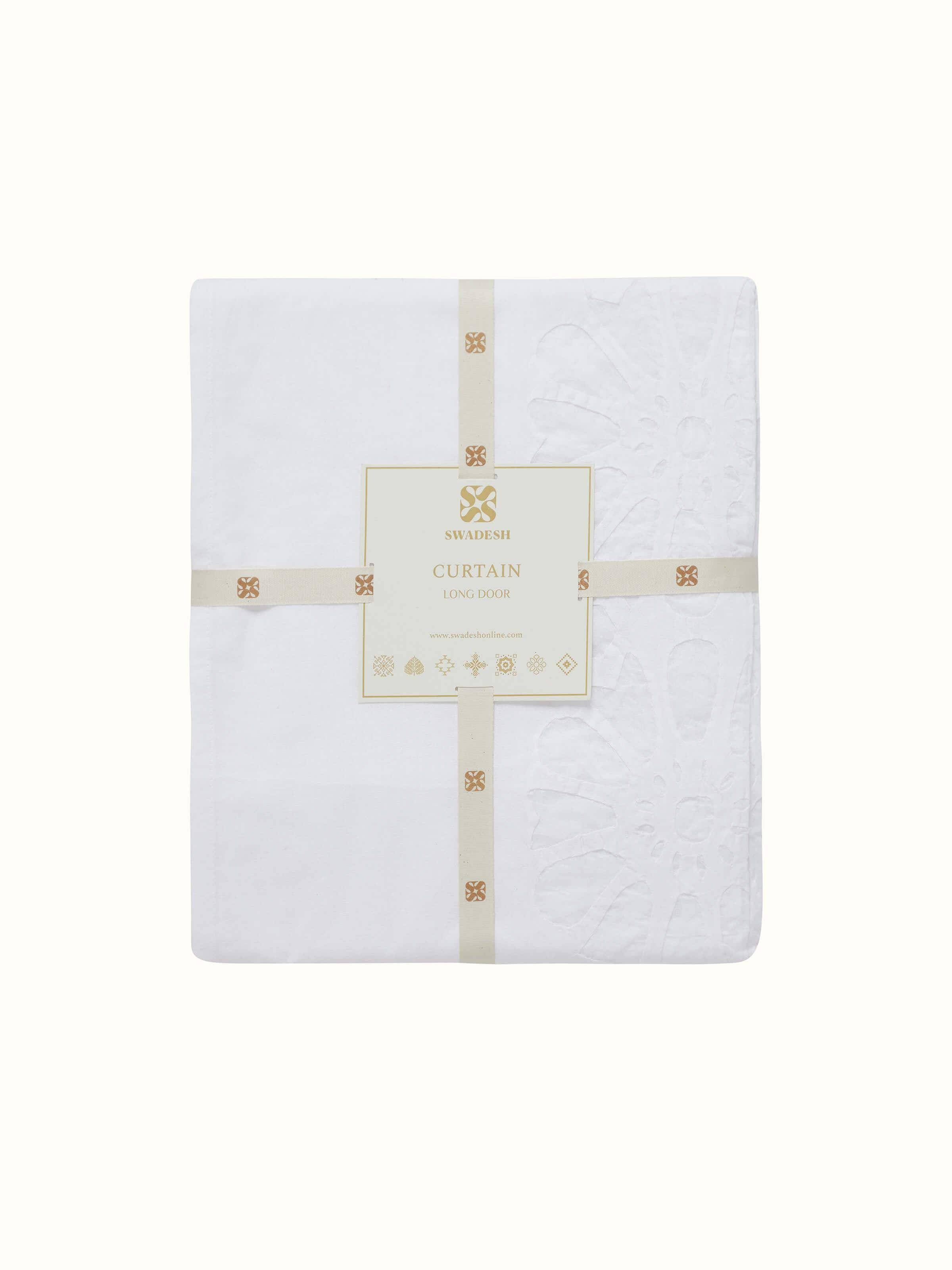 Detailed zoom of curtain fabric and craftsmanship of white jaal appliqué design