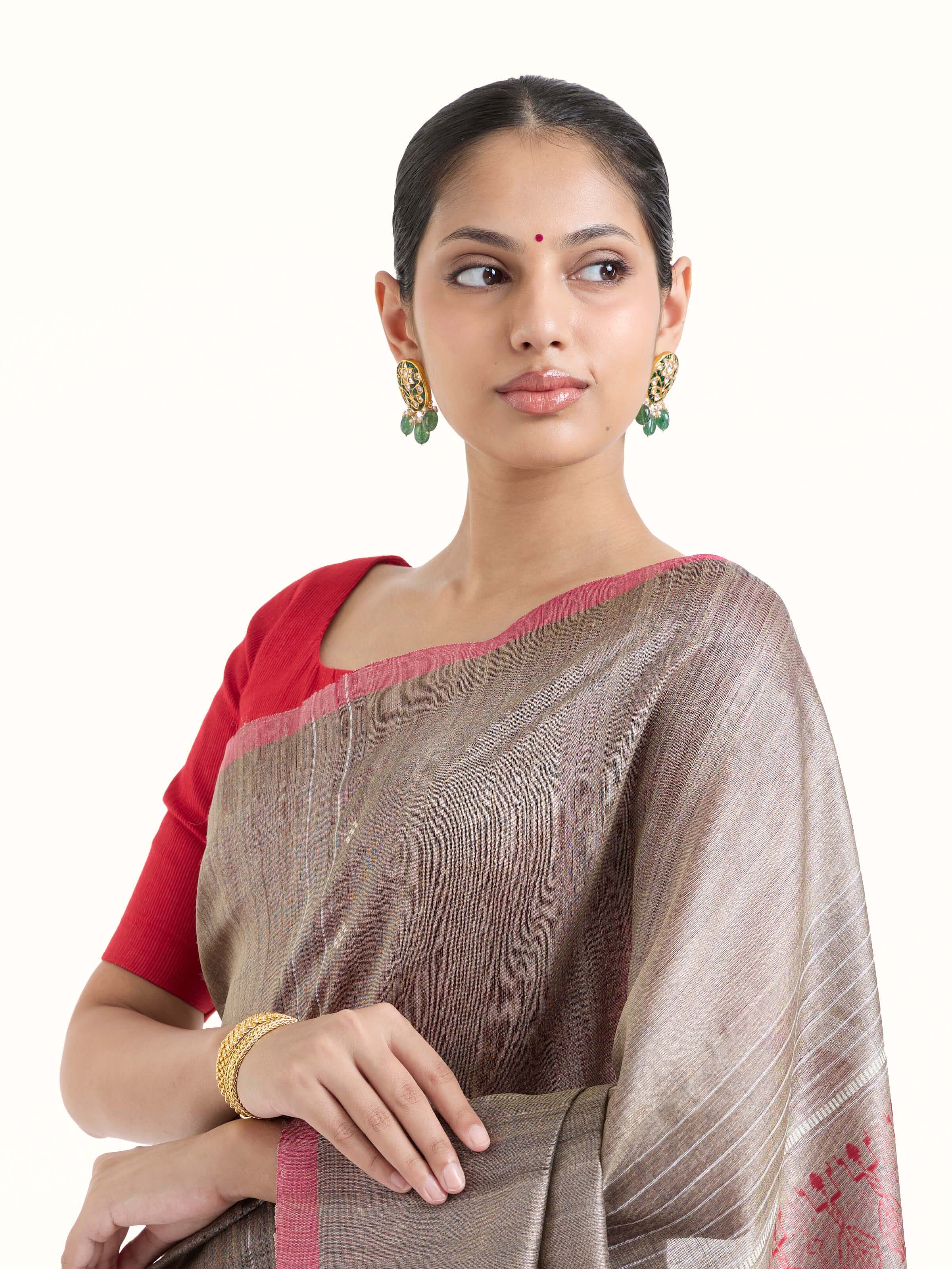 Angled view of beige tussar silk Odisha ikat saree highlighting ikat weave and texture