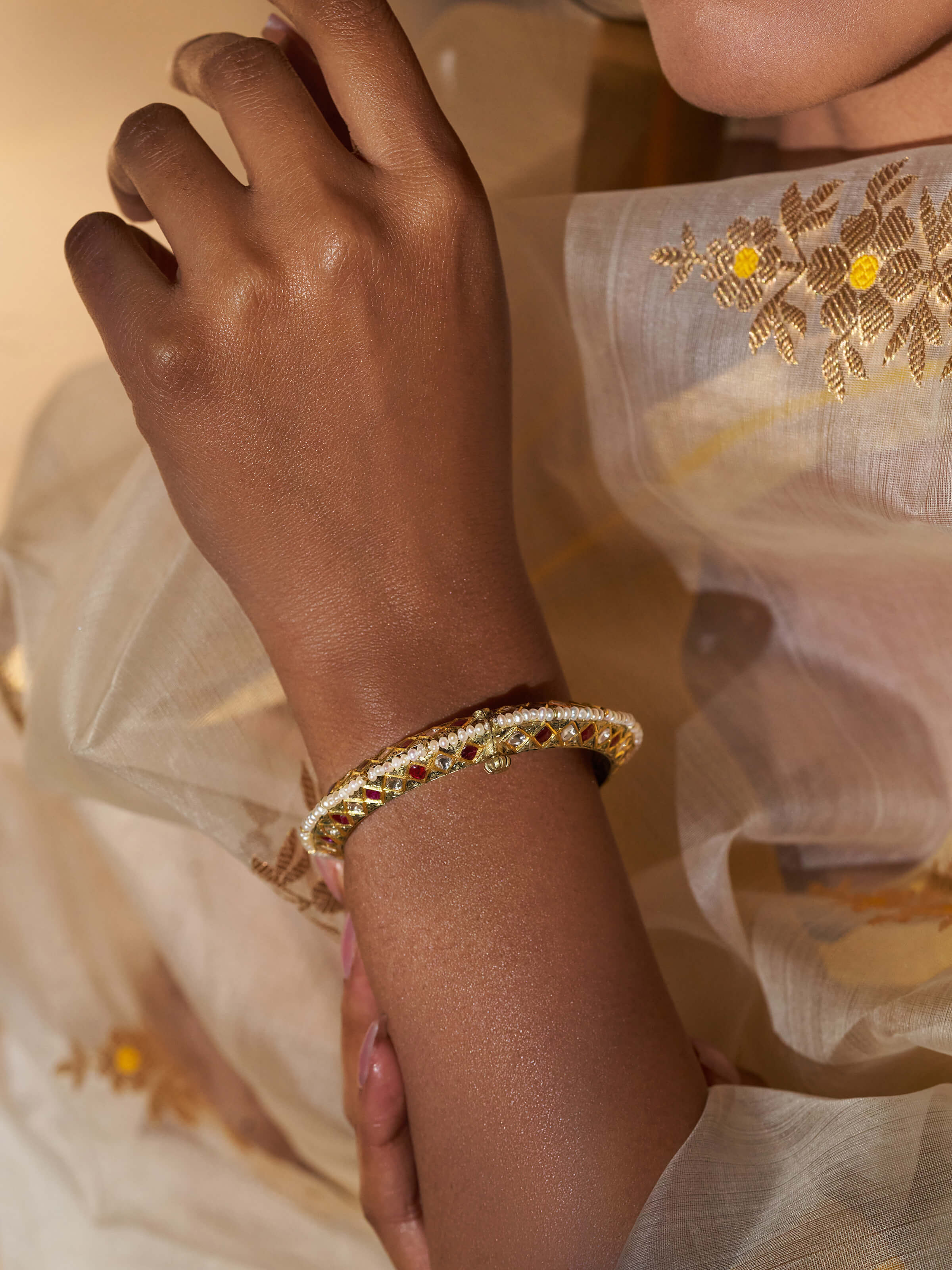 Close-up view of 18 karat gold bangle highlighting intricate design details