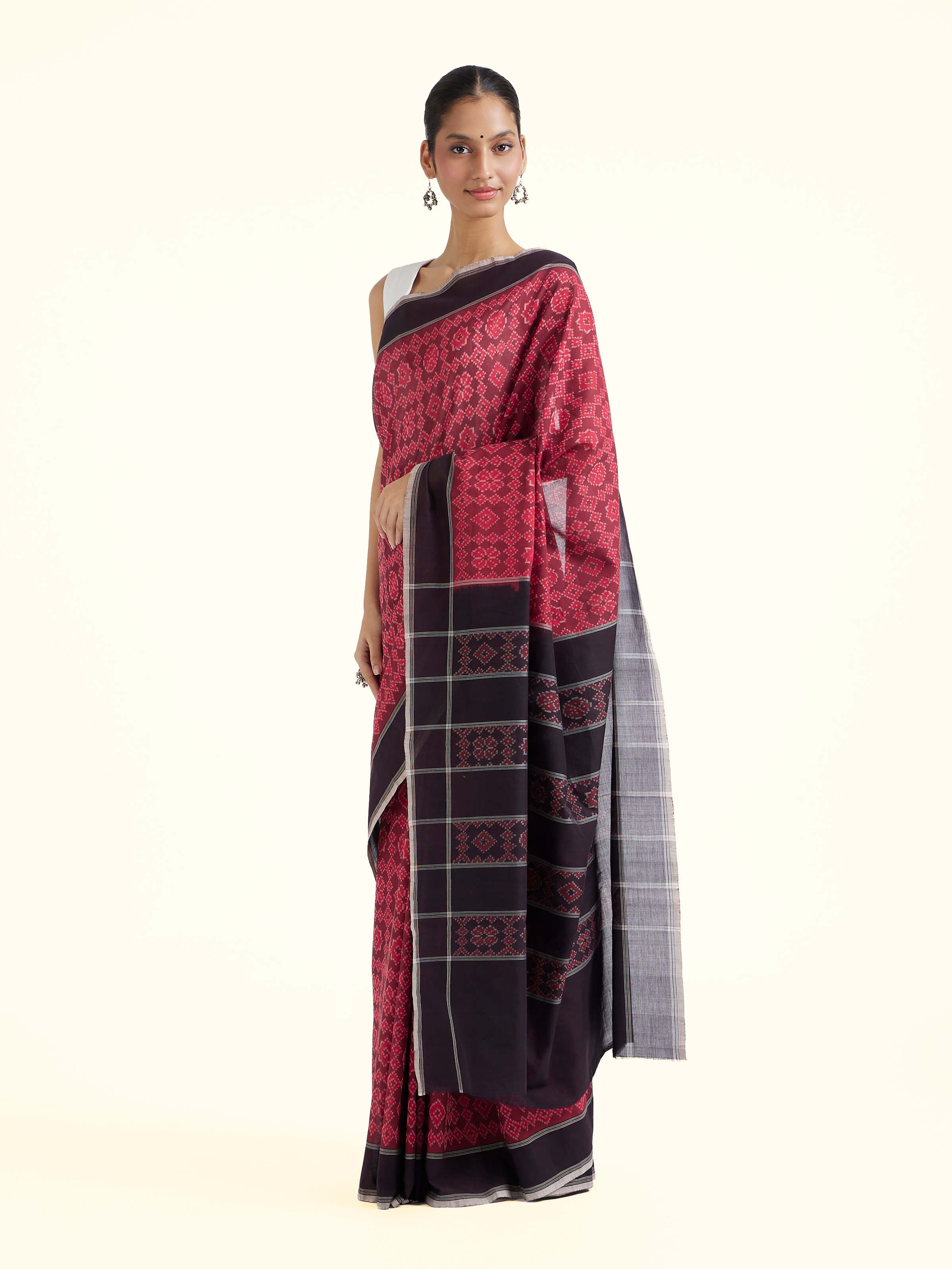 Side view of maroon mulberry silk ikat saree with graceful drape