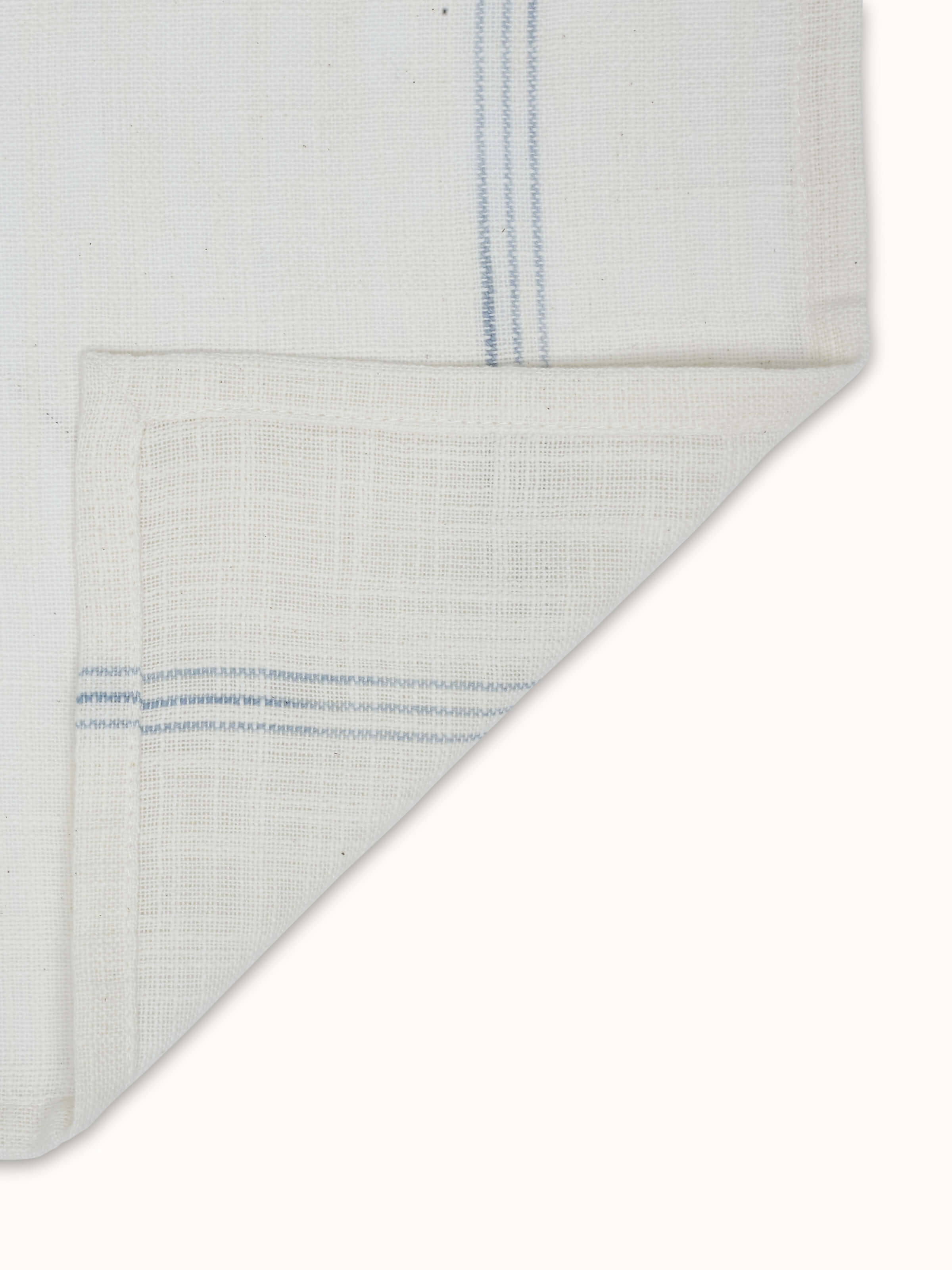 Back view of Arth light blue stripe cotton handloom dinner napkins showing clean reverse finish and uniform stitching.