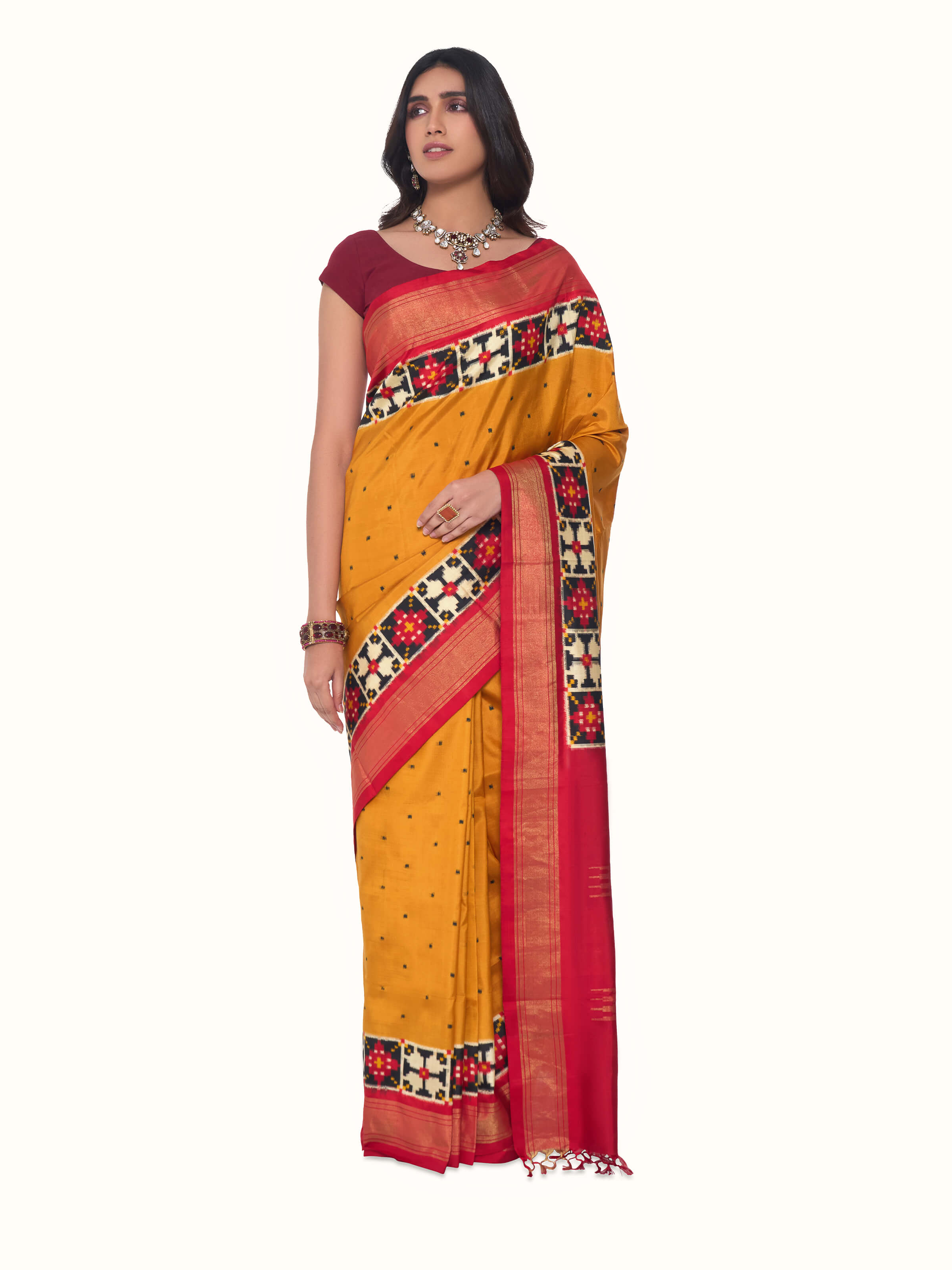 Front view of yellow silk Pochampally double ikat saree showcasing geometric ikat motifs