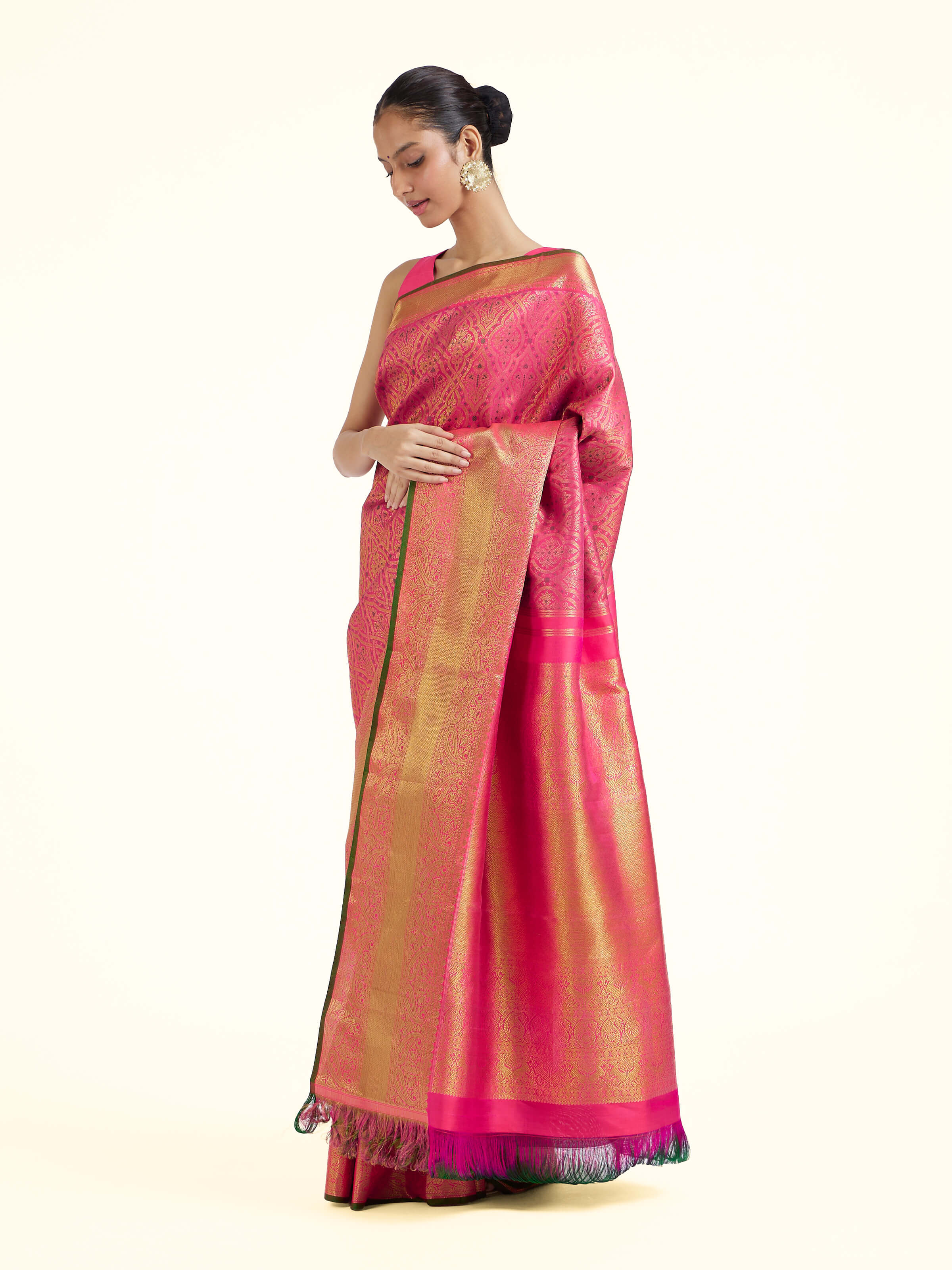 Side view of pink silk Kancheepuram saree with graceful drape and contrast border