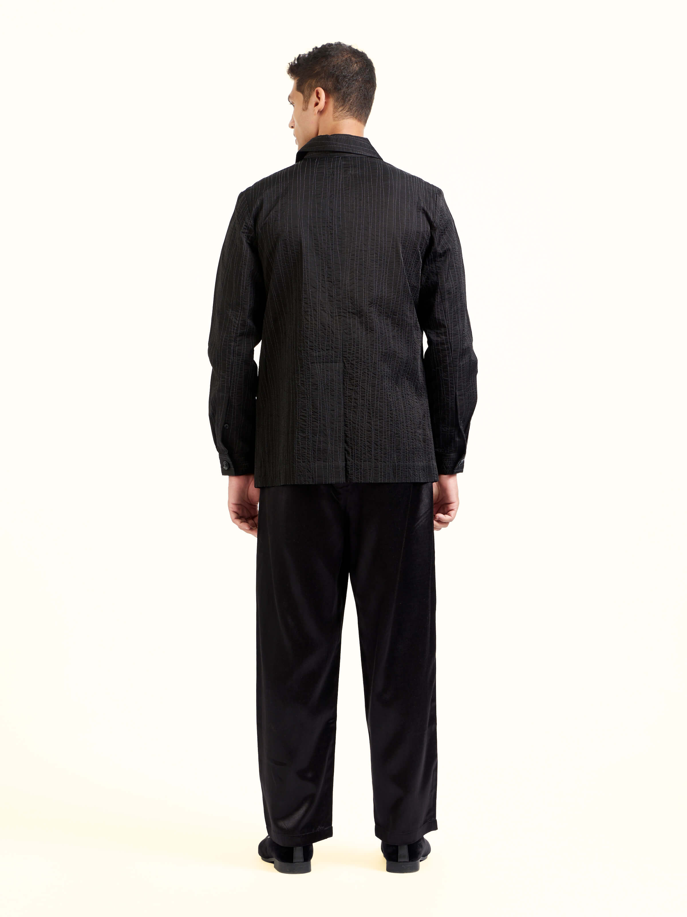 Back view of black quilting ethnic jacket displaying overall design