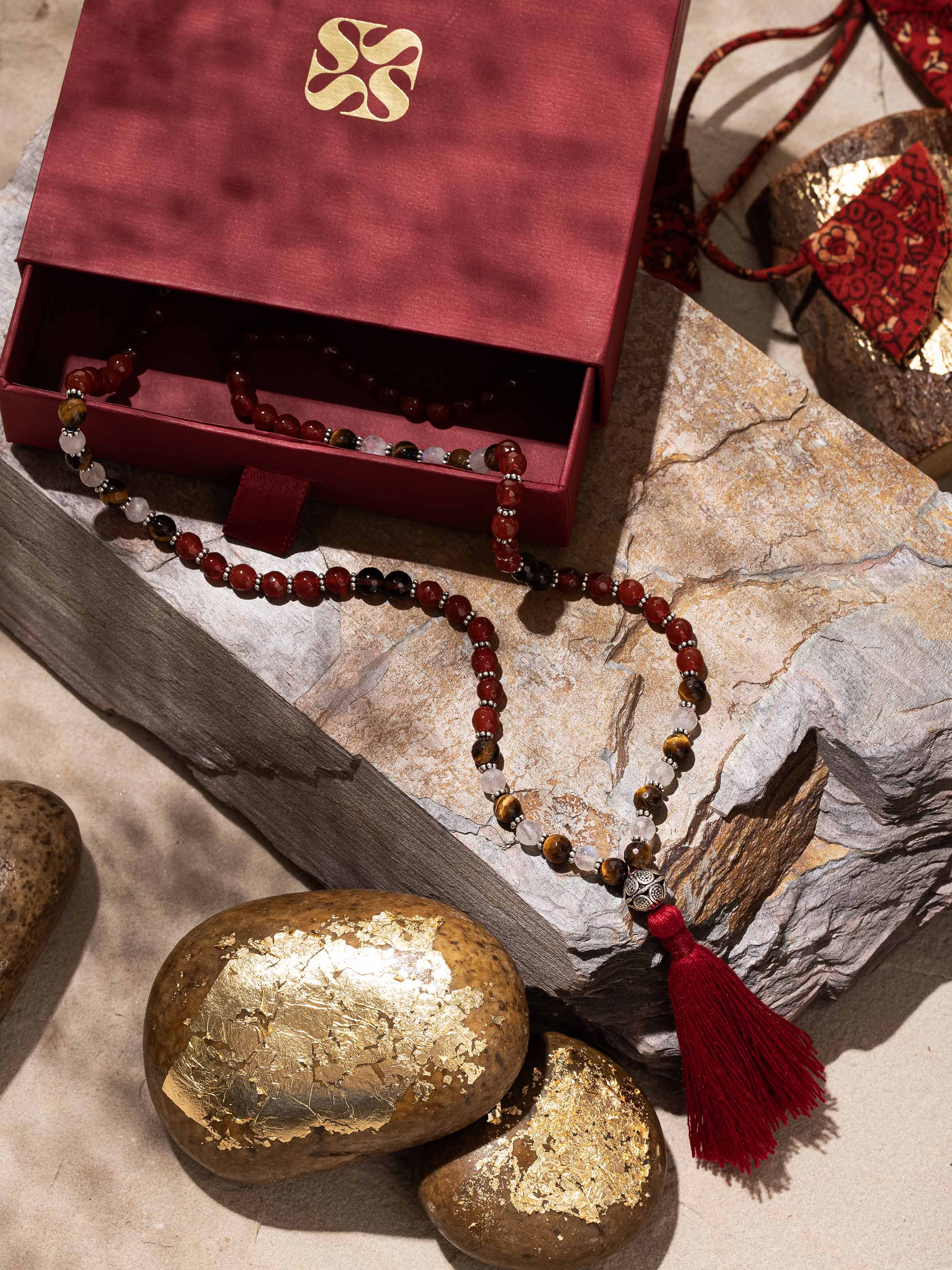 Lifestyle image of spiritual mala worn with earth-tone beads for grounding and strength