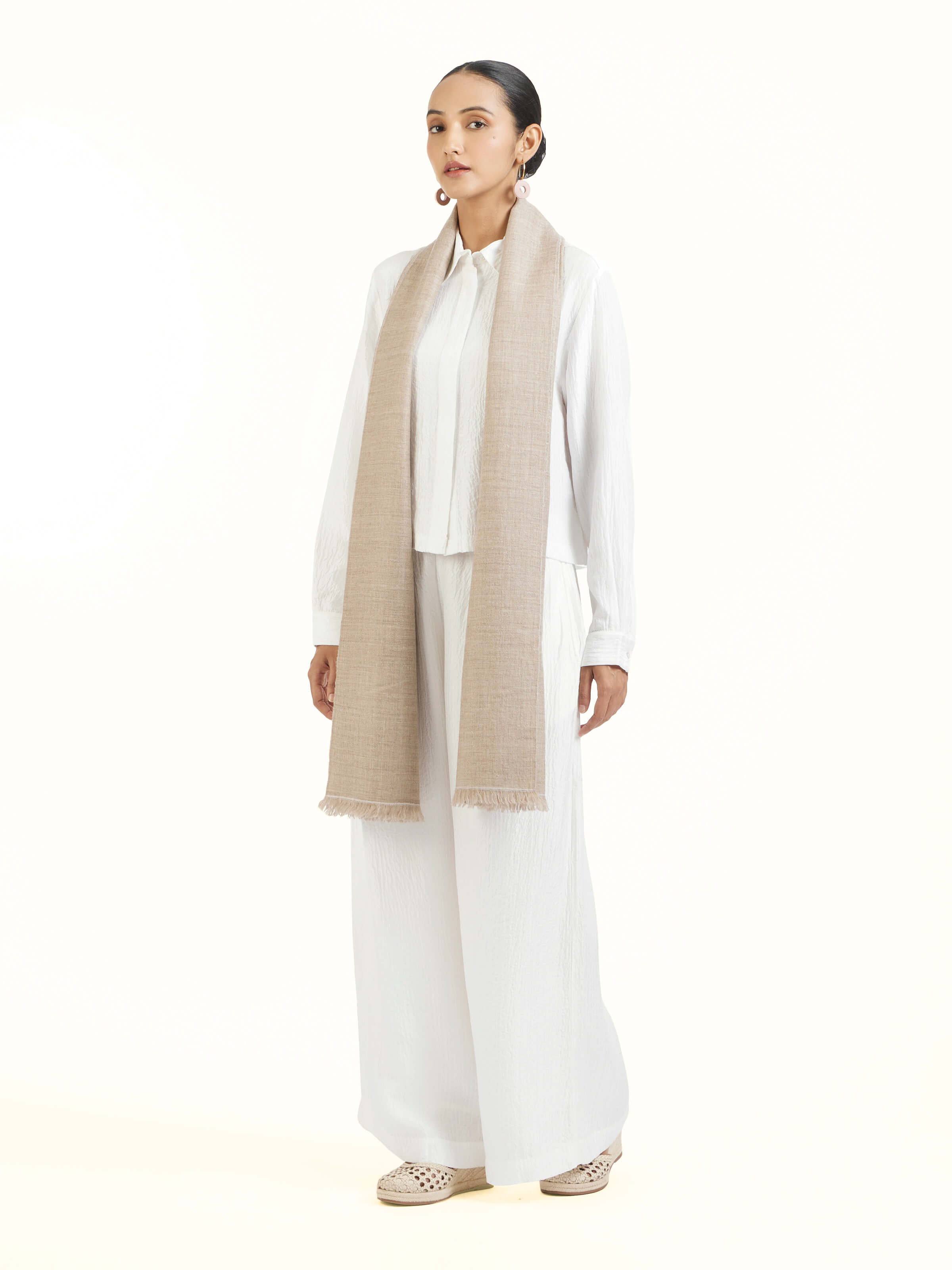 Side view of beige cashmere stole highlighting drape and luxurious feel