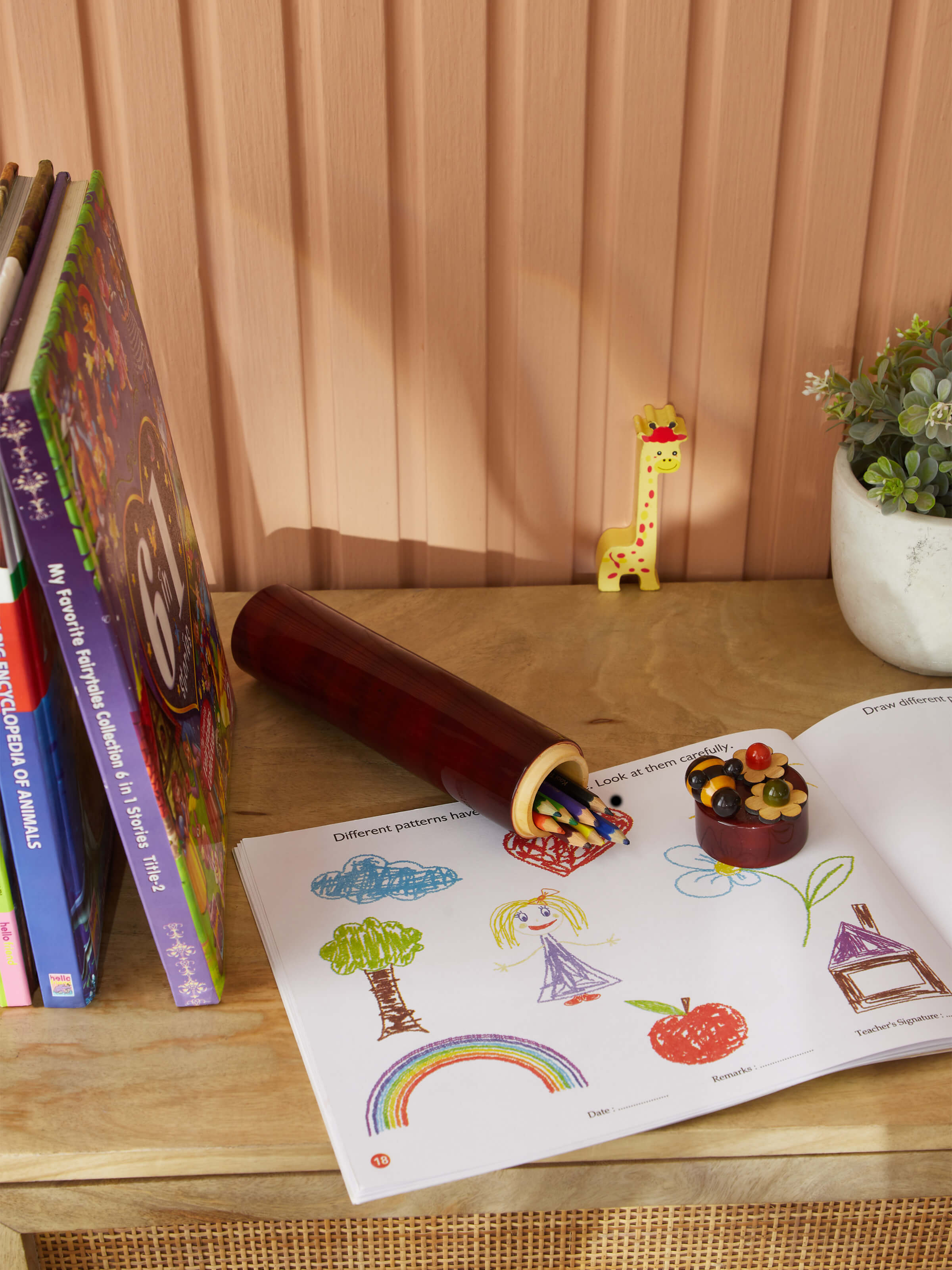 Side view of Channapatna Ivory Wood Sketch Kase in Red showcasing detailed carvings