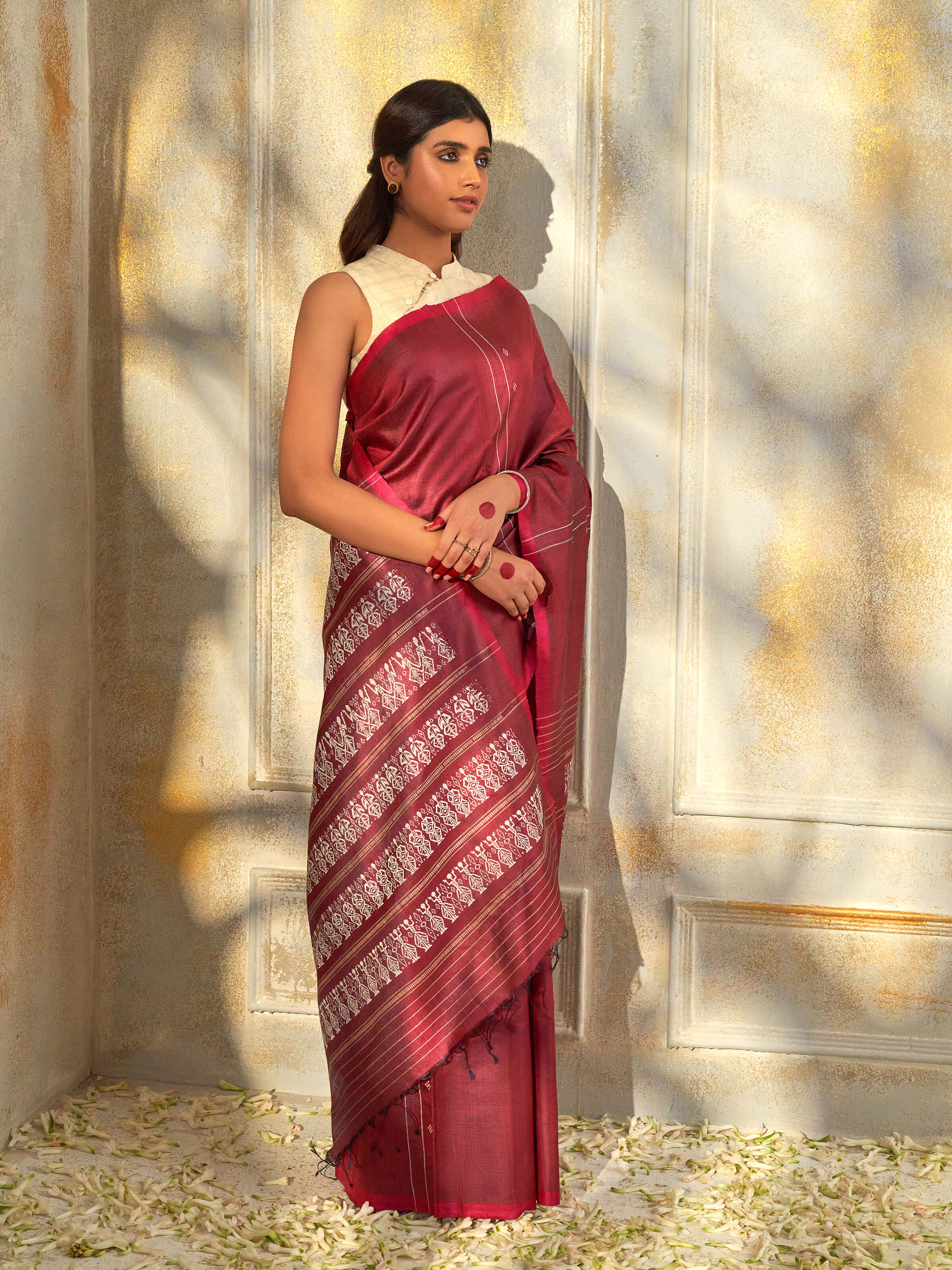 Side view of maroon tussar silk Odisha ikat saree with elegant drape