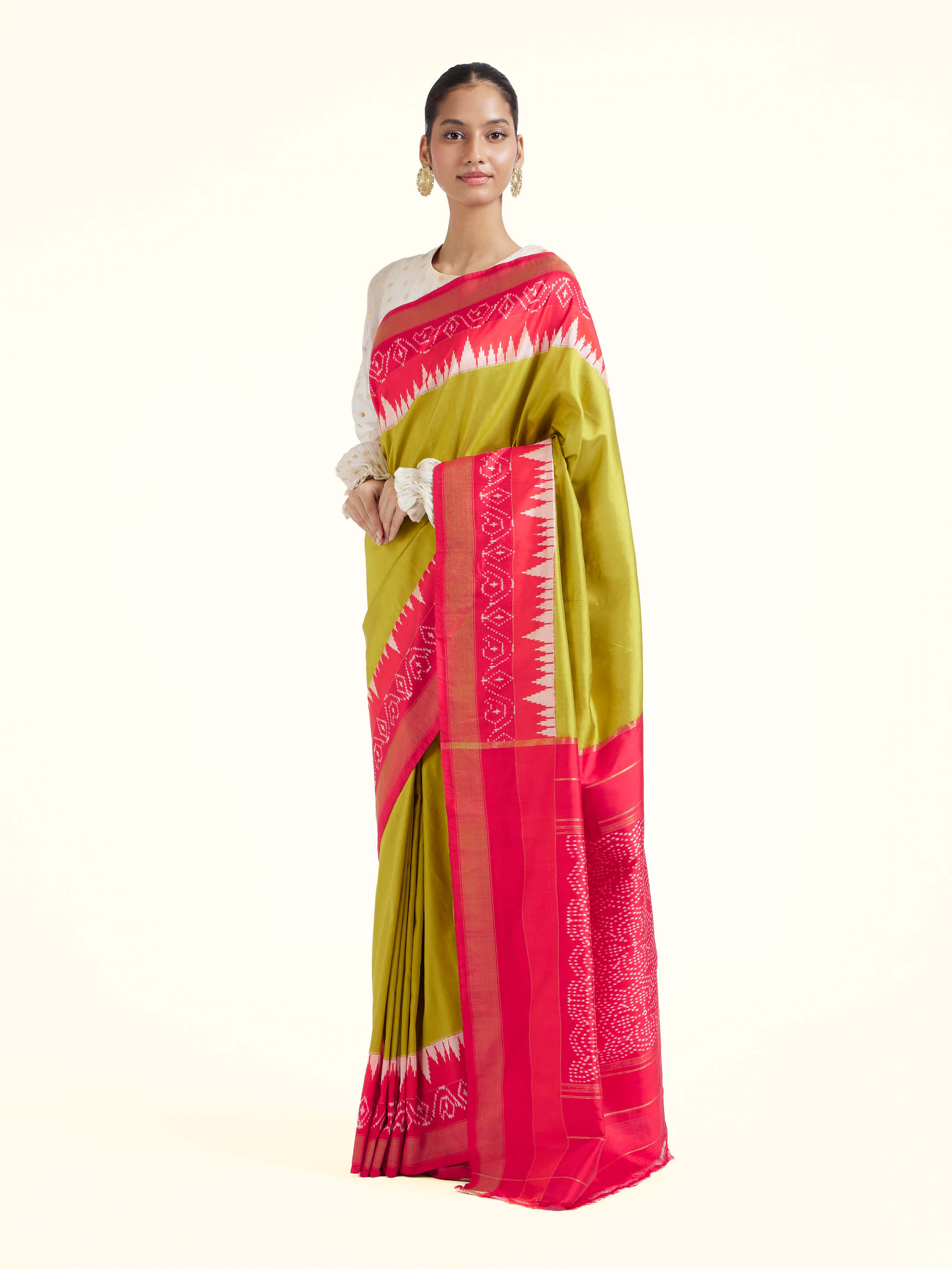 Side view of mustard mulberry silk ikat saree showcasing graceful drape