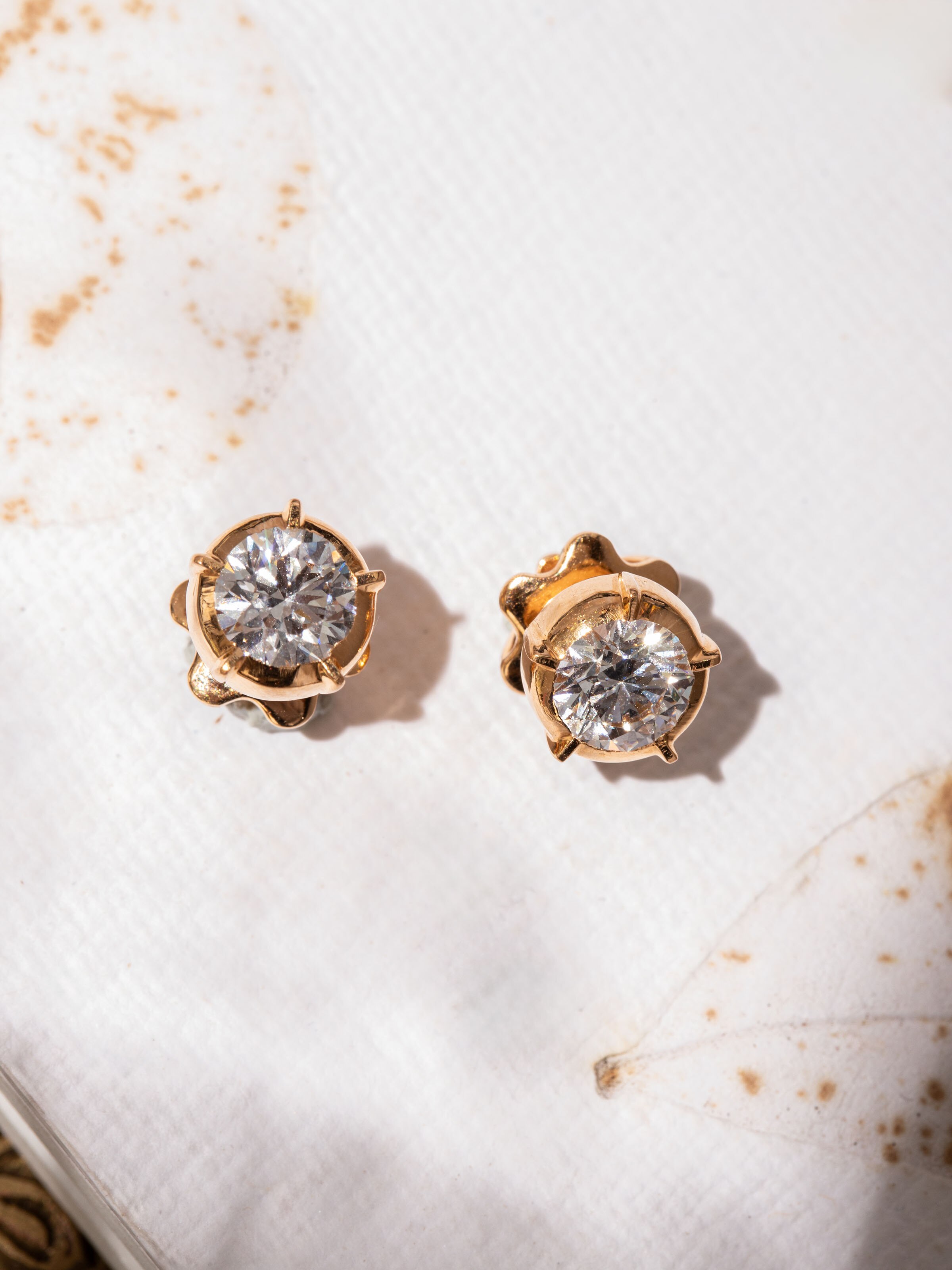 Alternate lifestyle view of Close-setting 22 Karat Gold Studs worn with a side hairdo.