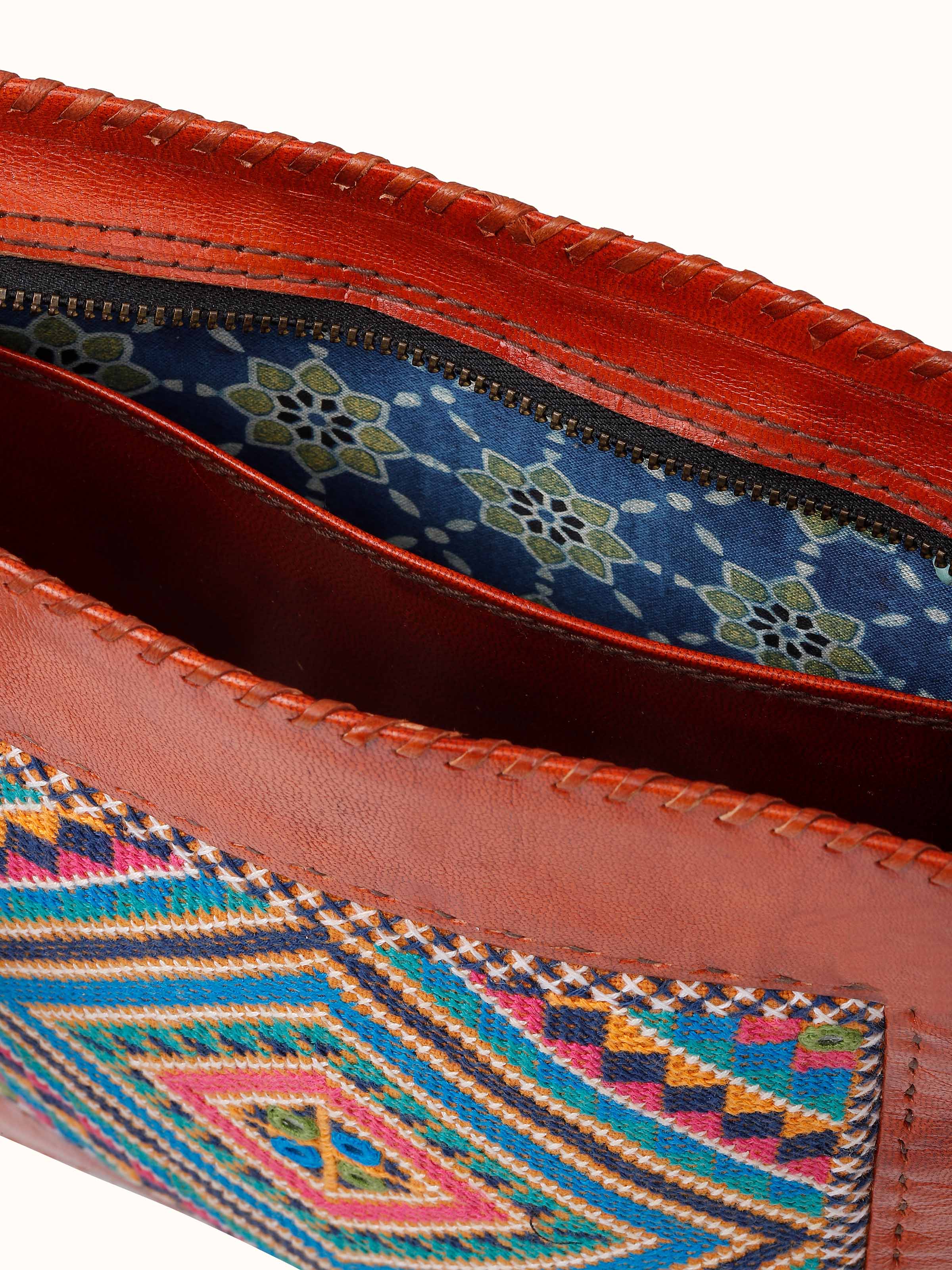 Detail shot capturing the intricate handwork and vibrant color palette, adding a unique accent to your outfit.