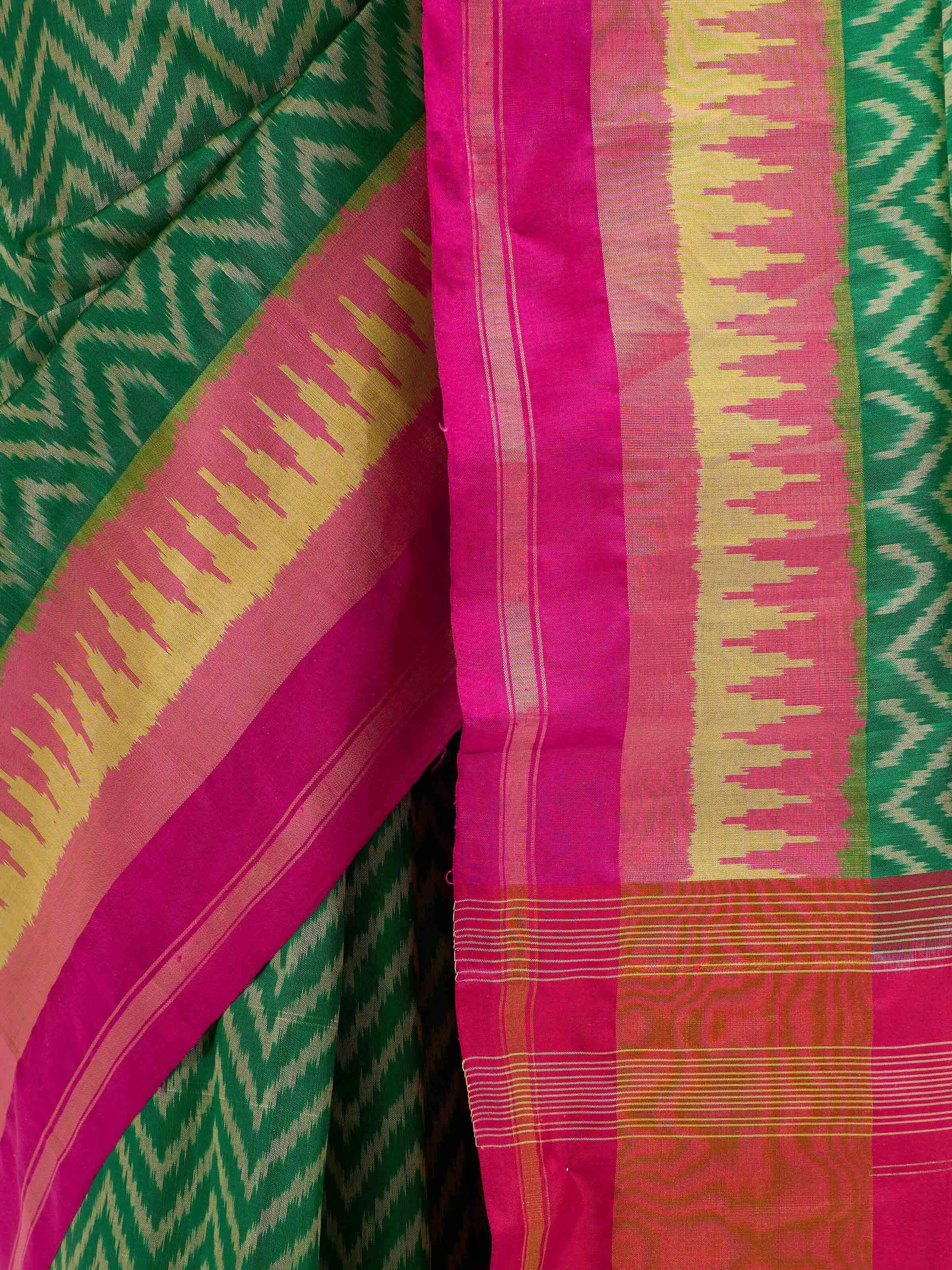 Detail view of green mulberry silk patola saree showing fabric texture and geometric weave