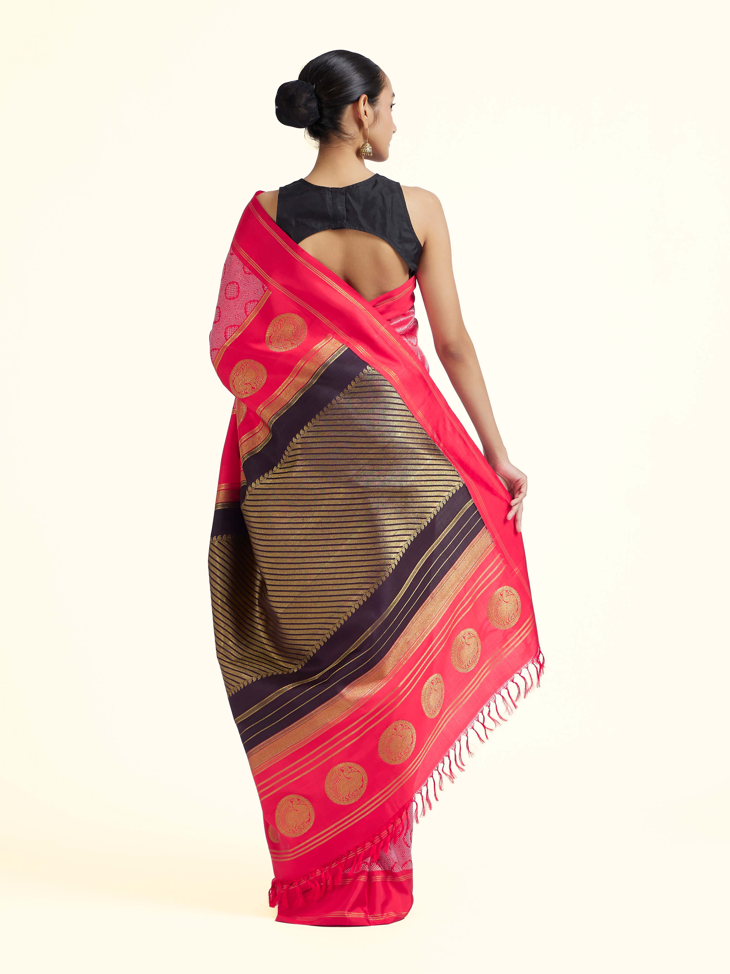 Back view of red silk Kancheepuram saree displaying ornate pallu design