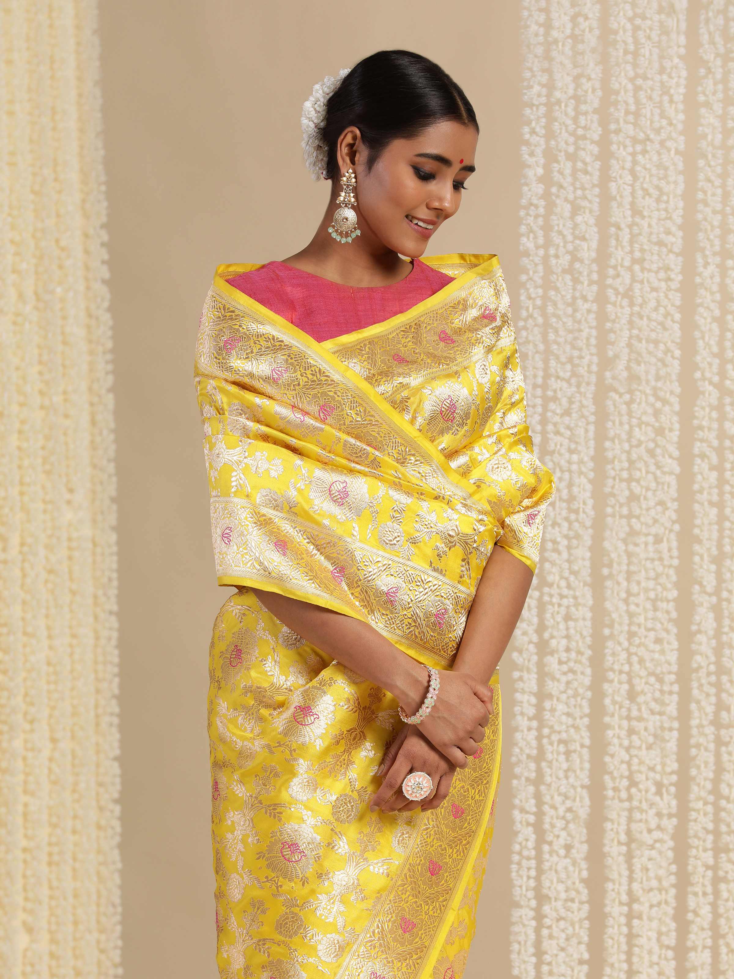 Angled view showing texture and zari patterns of yellow mulberry Katan silk Banarasi saree