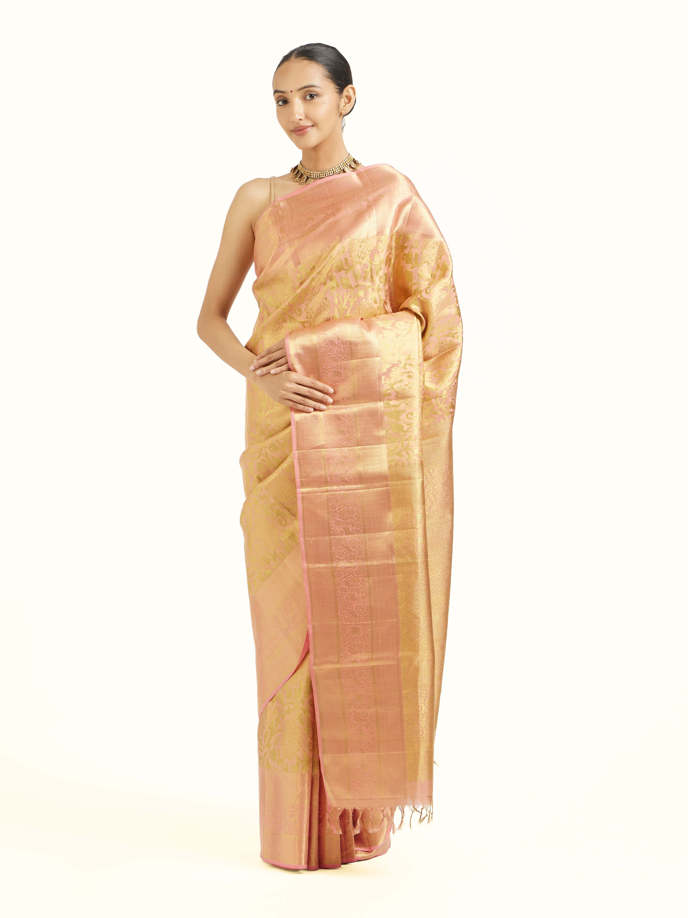 Side view of peach silk Kancheepuram saree with graceful drape and contrast border