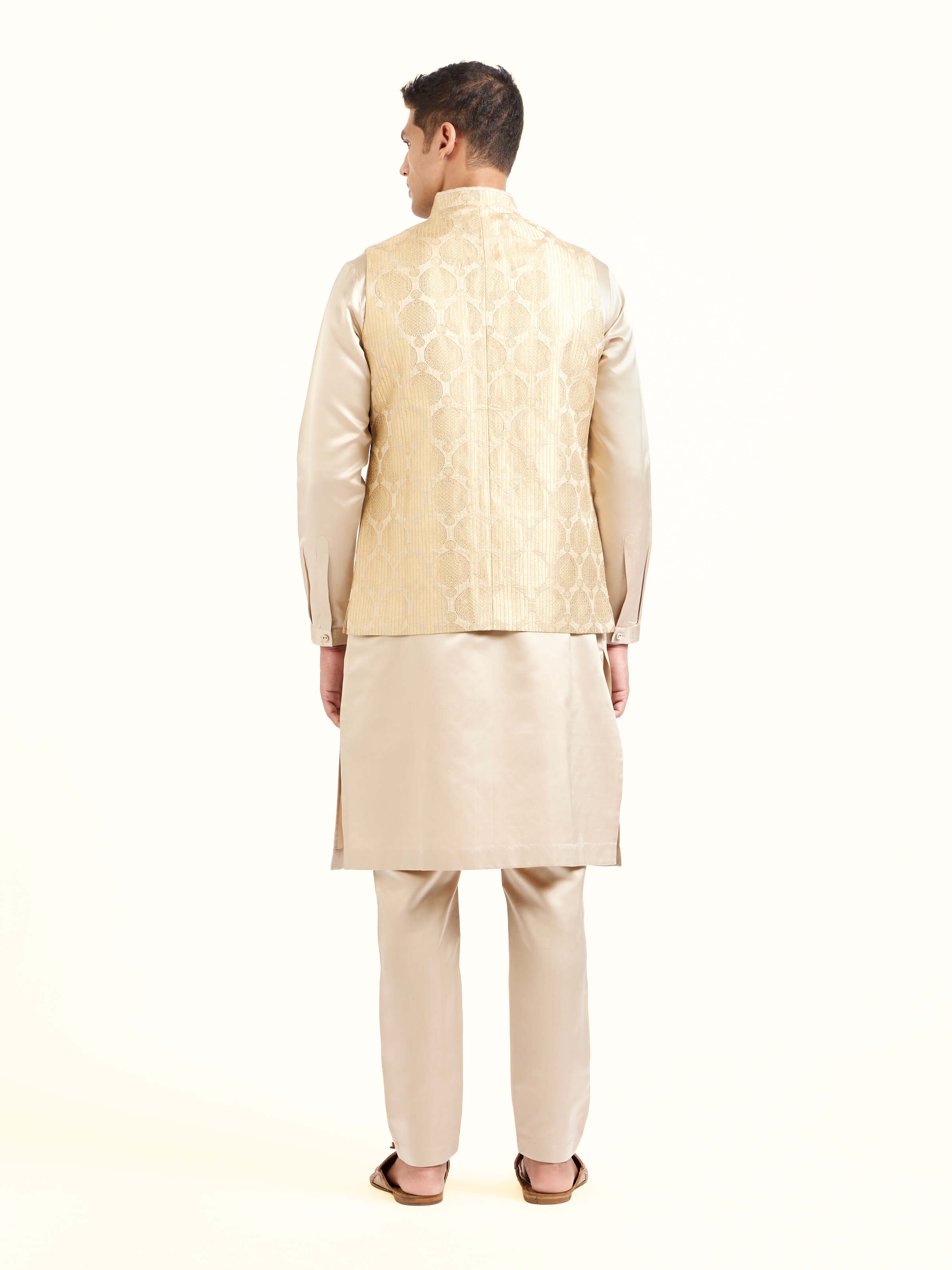Back view of beige silk Banarasi sleeveless jacket displaying overall design